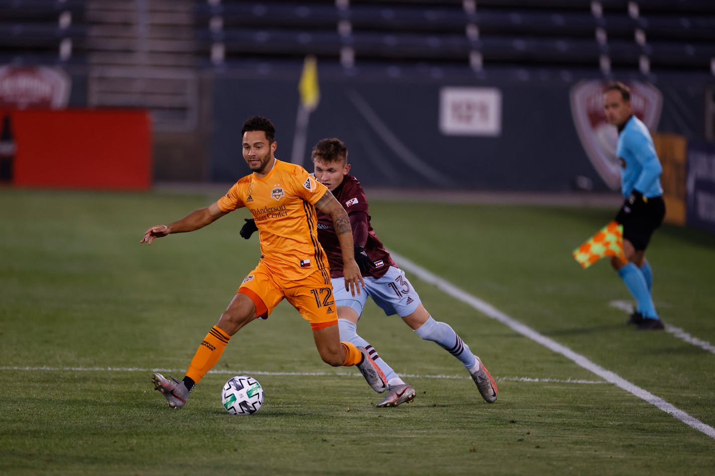 Houston Dynamo midfielder Niko Hansen (12) and Colorado Rapids defender Sam Vines (13) during the first half of an MLS soccer match Wednesday, Sept. 9, 2020, in Commerce City, Colo. (AP Photo/David Zalubowski)