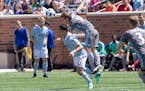 Minnesota United midfielder Collin Martin (17) goes over Sporting Kansas City midfielder Roger Espinoza (17) to make a play on the ball. [ Special to 