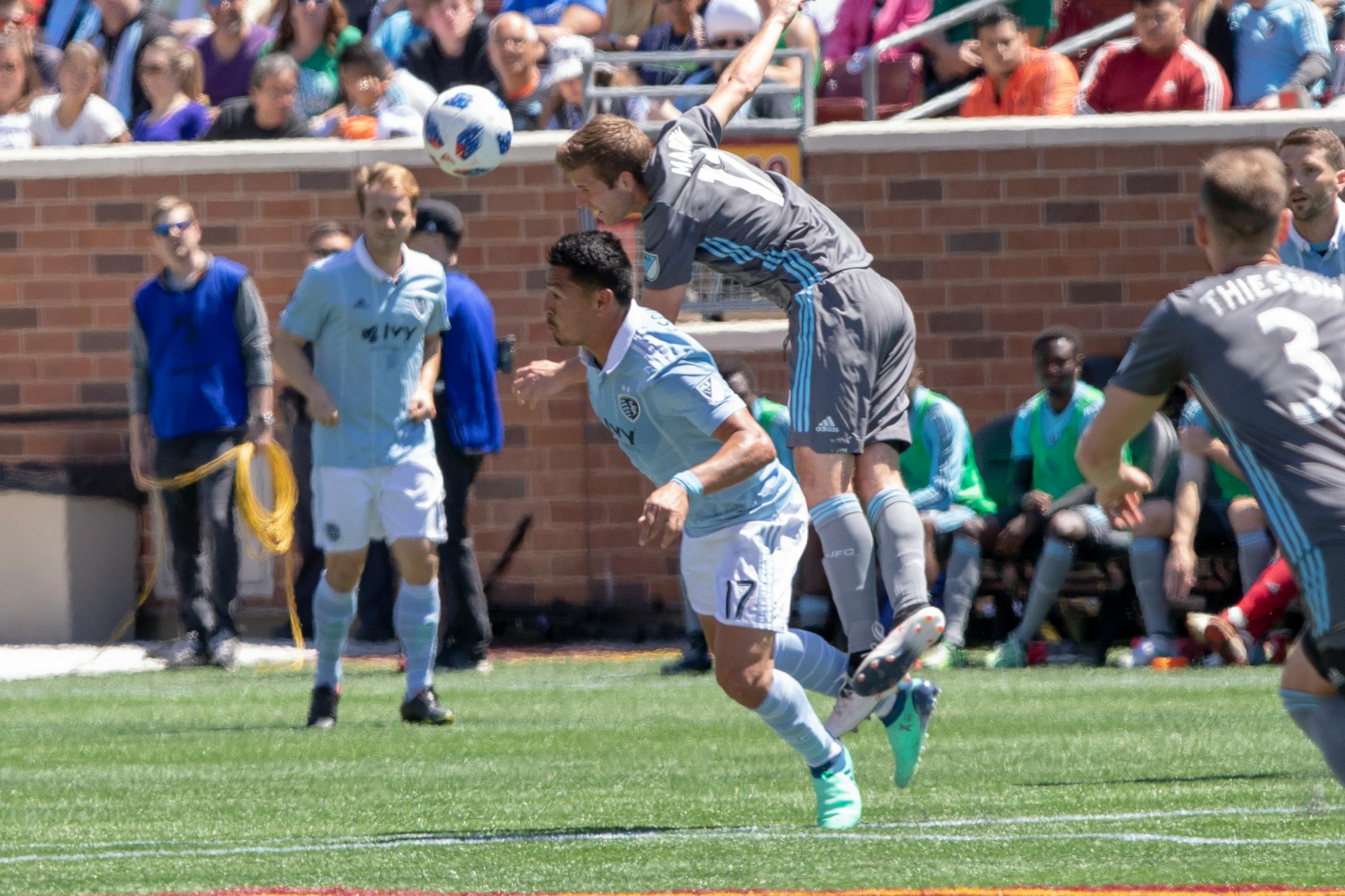 Minnesota United midfielder Collin Martin (17) goes over Sporting Kansas City midfielder Roger Espinoza (17) to make a play on the ball. [ Special to Star Tribune, photo by Matt Blewett, Matte B Photography, matt@mattebphoto.com, Minnesota United FC vs. Sporting KC, MLS Soccer, TCF Bank Stadium, 1006061755 LOON05211