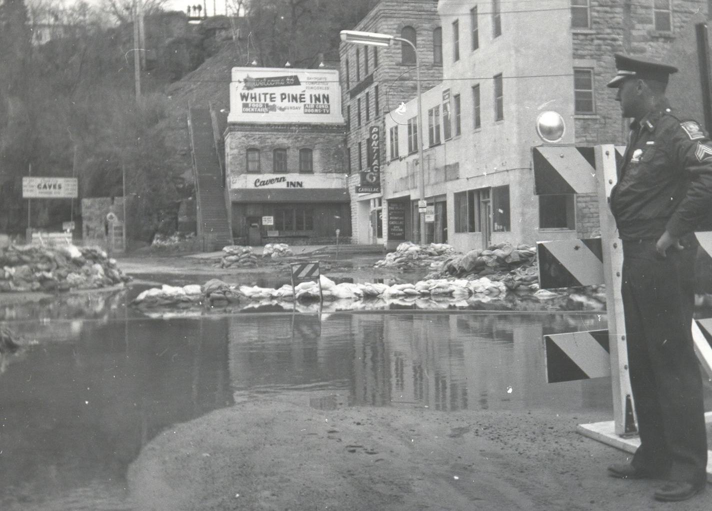 Stillwater police guarded south Main Street, near the city's legendary stone stairs, as floodwater soaked businesses.