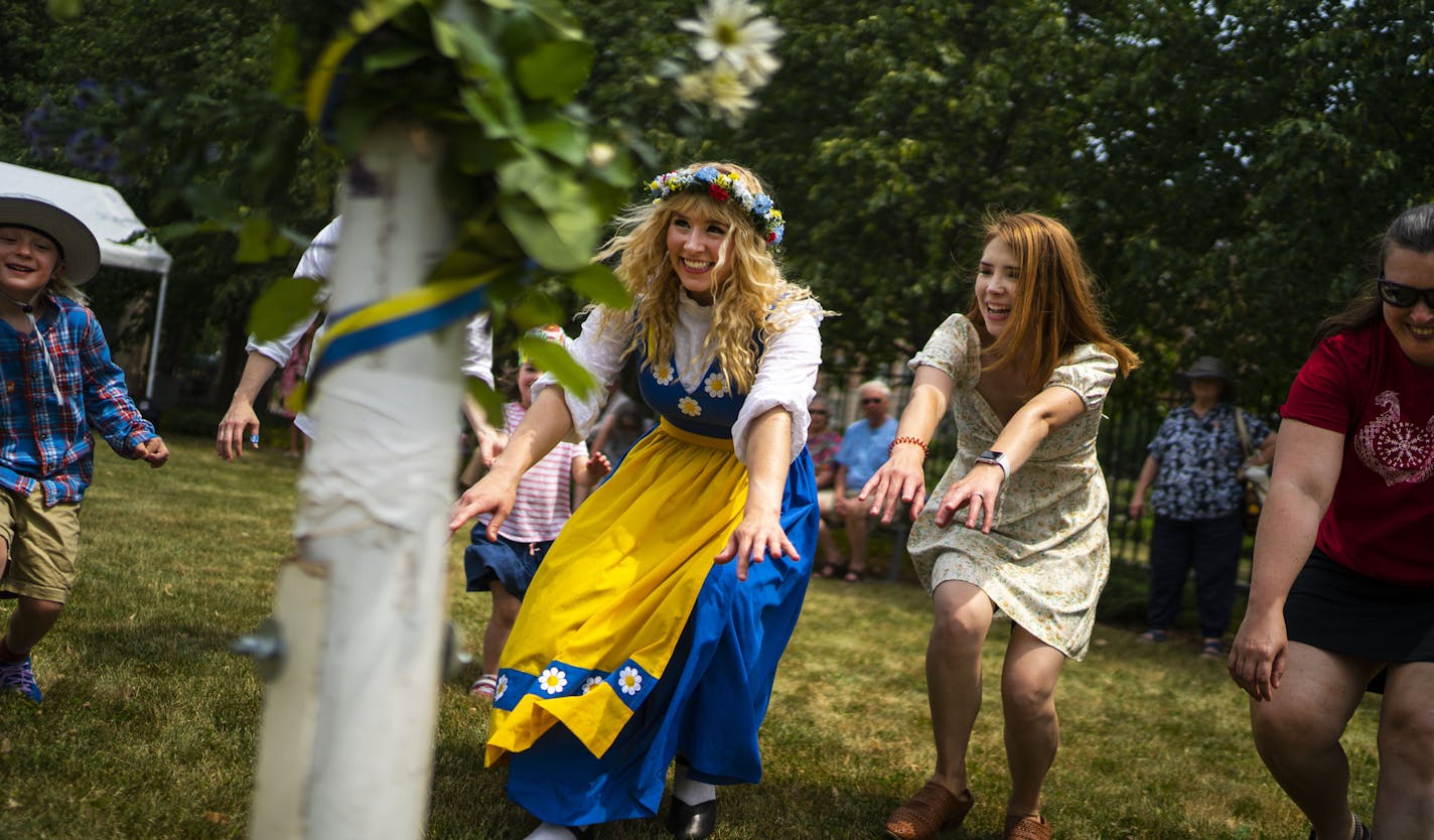 Sisters Natalie Redinger, center, and Heather Dewitt, right, did a traditional circle dance at the American Swedish Institute on Thursday.