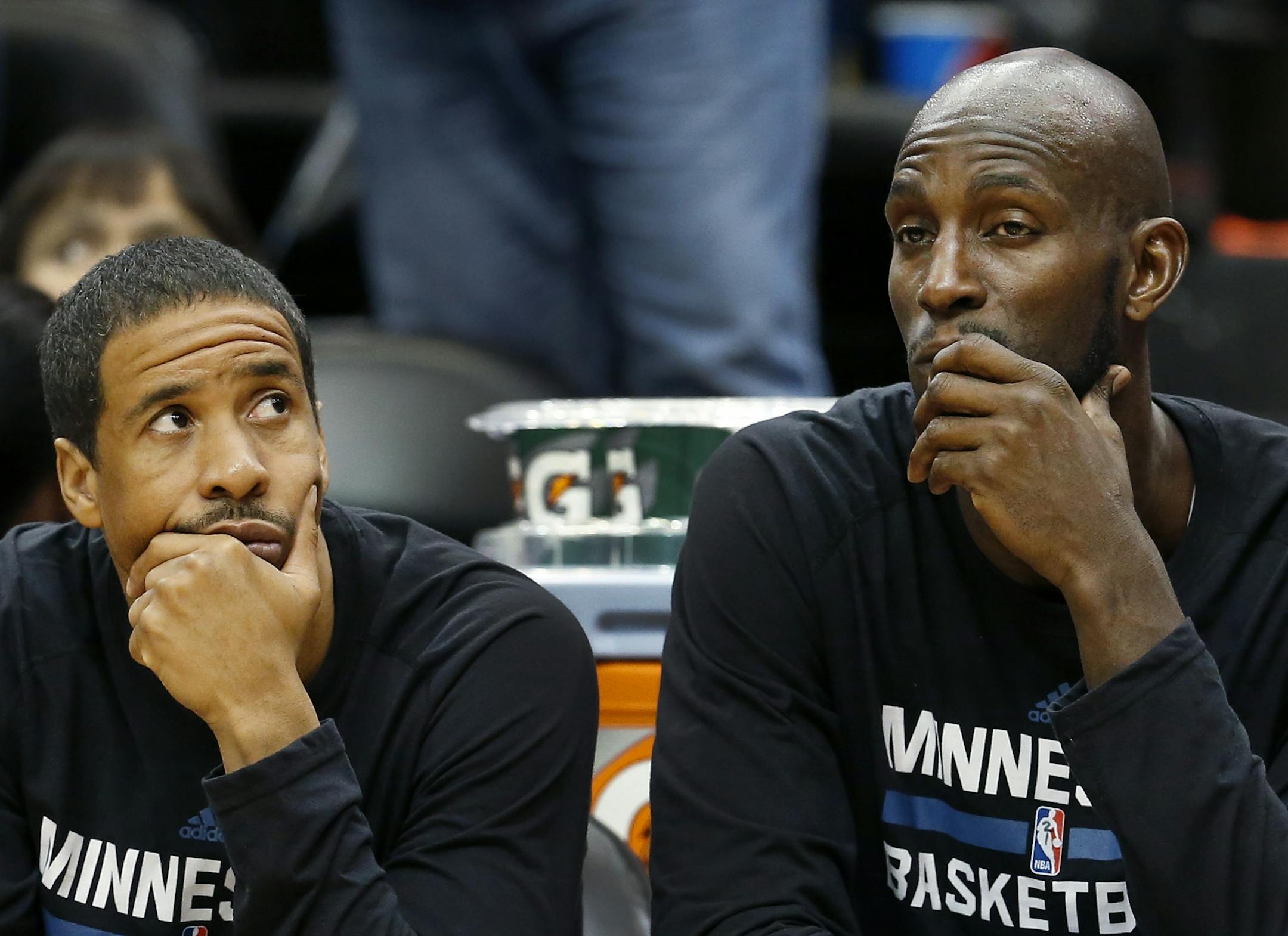 Timberwolves Andre Miller and Kevin Garnett watched from the bench in the fourth quarter. Denver beat Minnesota by a final score of 78-74.