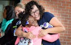 Kindergarten teacher Sadie Fitzgerald greeted former student, now first grader Raykia Harris with a big hug as she returned to Lucy Laney Elementary S