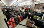 Baggage stacks up from delayed travellers in the baggage claim area in Denver International Airport Wednesday, June 16, 2021, in Denver.  The Biden ad