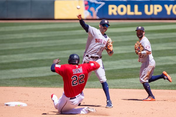 Houston Astros shortstop Carlos Correa (1) throws to first on a double play with Minnesota Twins first baseman Miguel Sano (22) out at second and Astr