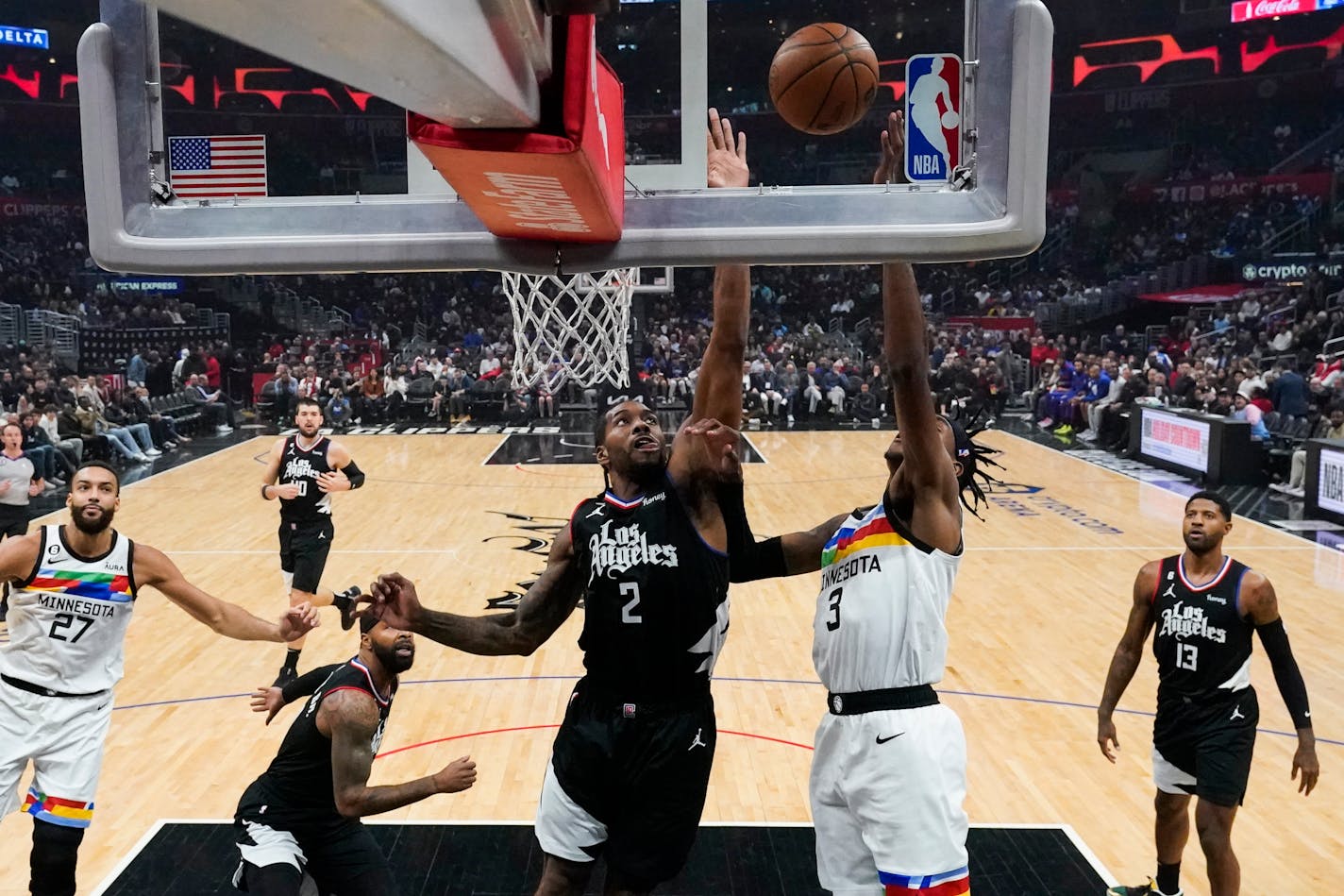 Los Angeles Clippers forward Kawhi Leonard (2) defends against Minnesota Timberwolves forward Jaden McDaniels (3) during the first half of an NBA basketball game in Los Angeles, Wednesday, Dec. 14, 2022. (AP Photo/Ashley Landis)