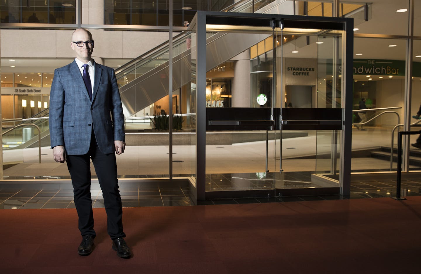 Dan Collison, of the Minneapolis Downtown Council, posed in a vacant retail space, previously used as a theater lobby, in the City Center building in Minneapolis, Minn., on March 22, 2018. ] RENEE JONES SCHNEIDER &#x2022; renee.jones@startribune.com