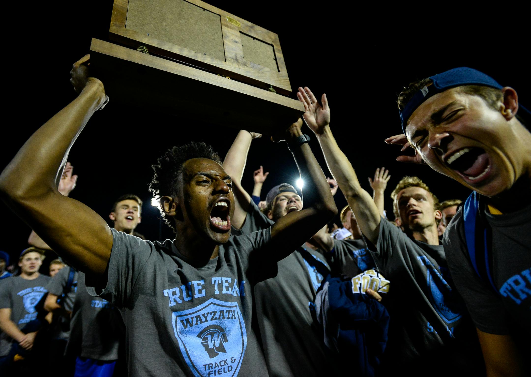 Gemechu Meskele, left, Ben Grosse, far right, and others celebrated Wayzata's True Team state title. (Aaron Lavinsky, Star Tribune)