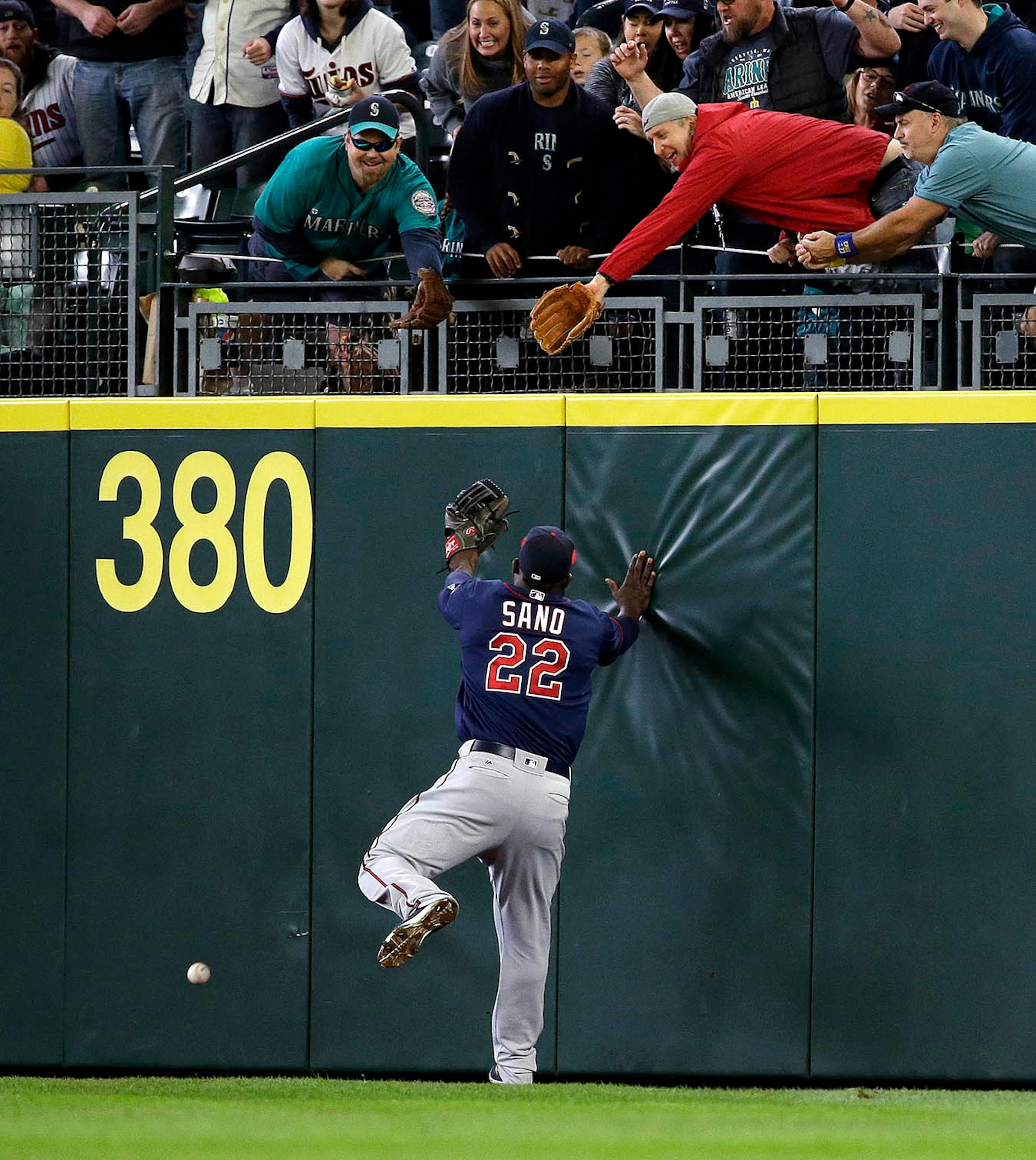 Minnesota Twins right fielder Miguel Sano hits the wall after missing catching a fly ball from Seattle Mariners' Kyle Seager in the second inning of a baseball game Sunday, May 29, 2016, in Seattle. Seager doubled on the play.