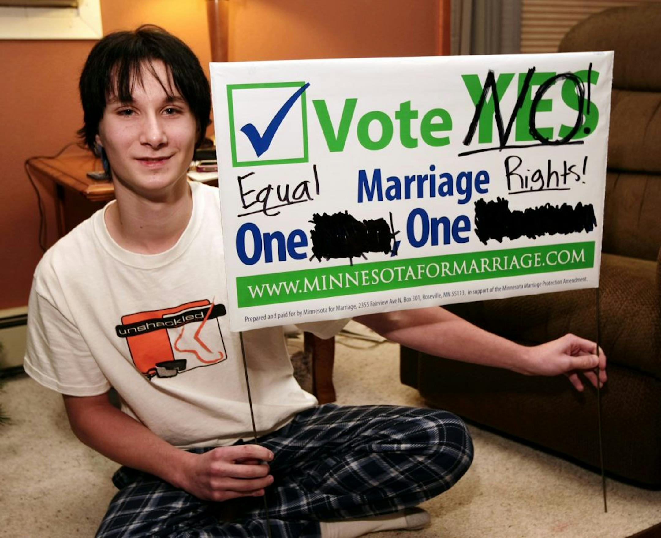 Lennon Cihak held up the sign that he photographed and posted on his Facebook page. His family says he was later barred from taking part in his Catholic confirmation at a Barnesville, Minn., church.