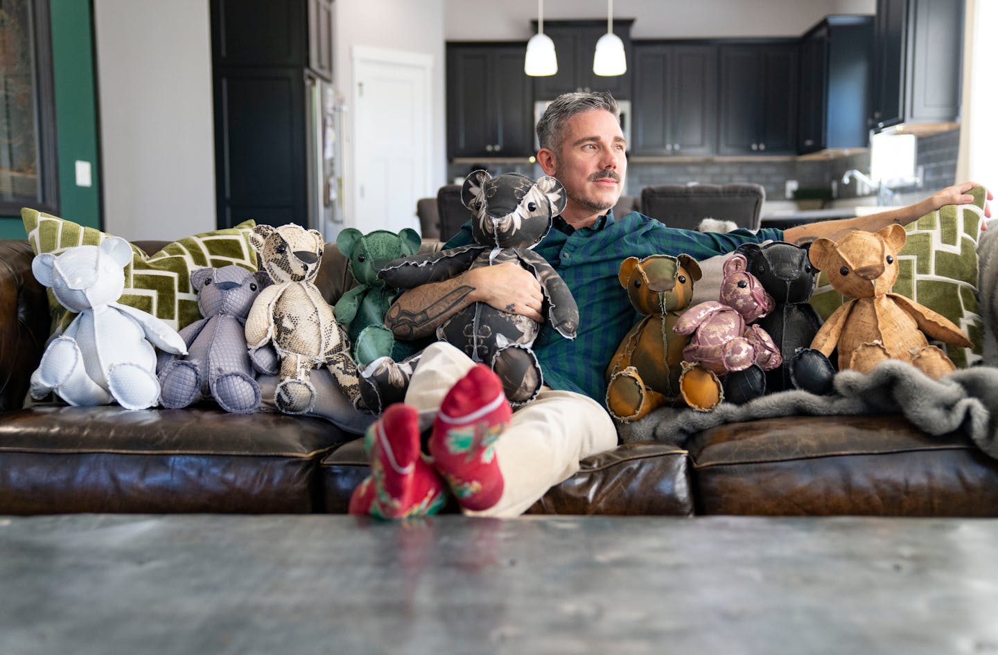 Christopher Straub poses for a portrait with some of his "Inside-Out Critters" Tuesday, September 20, 2022 at his home in Shakopee, Minn. ]