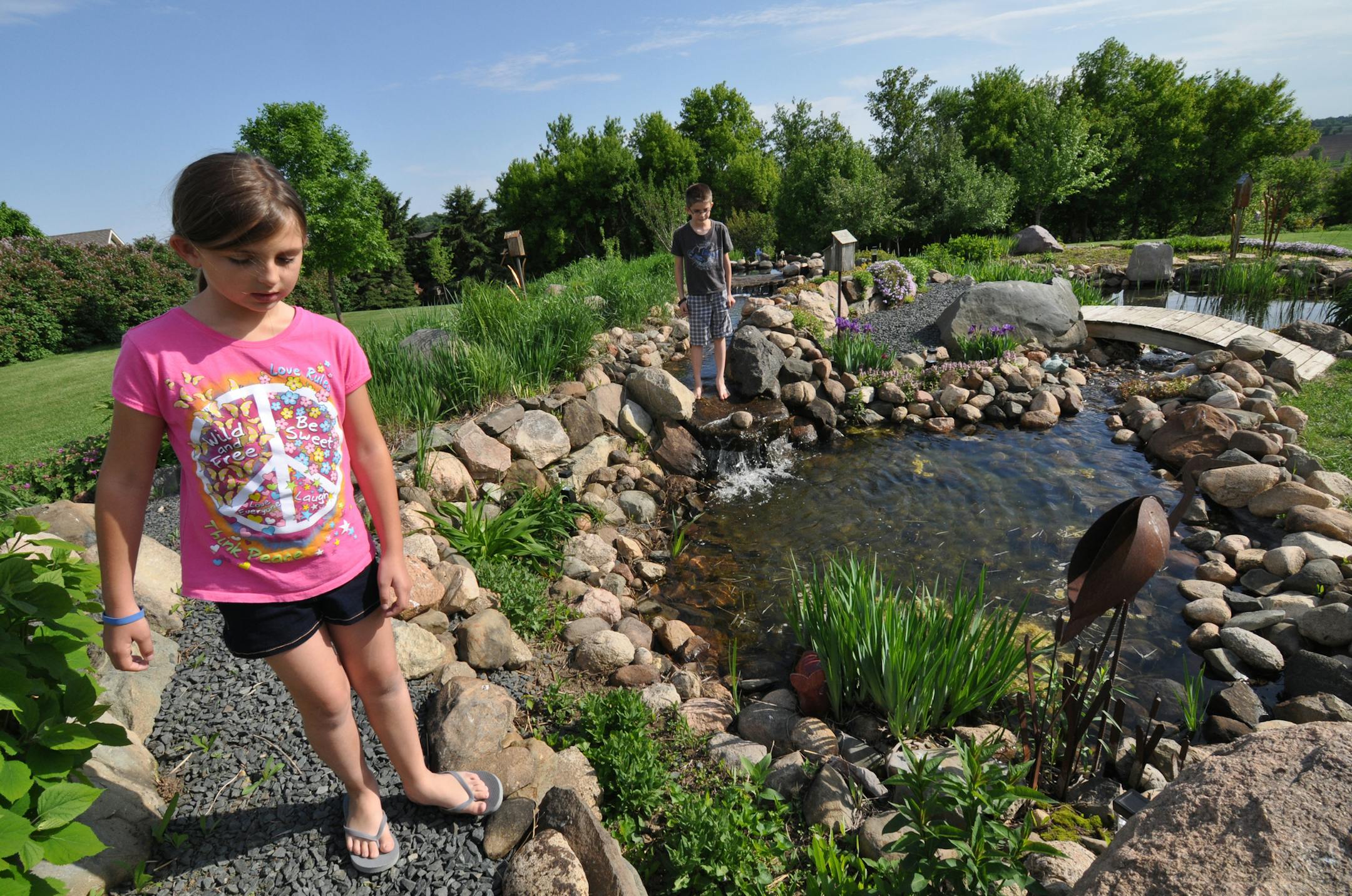 Photo by Liz Rolfsmeier Elizabeth, 9, and Matthew, 8, Reinardy, explored a water garden on their family's property south of Hastings.