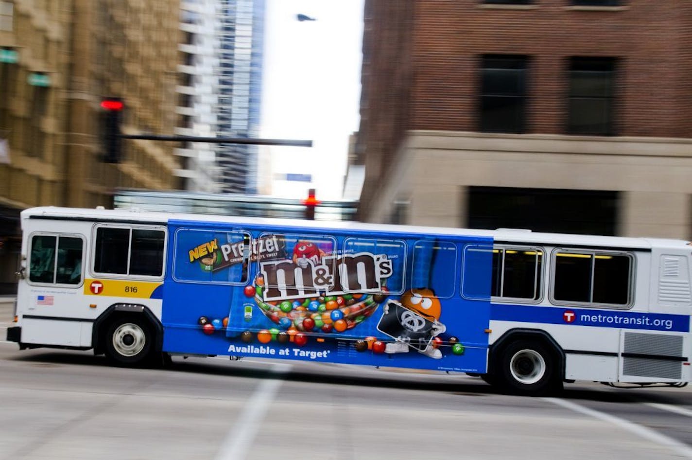 A Metro Transit city bus glides through an intersection in downtown Minneapolis.