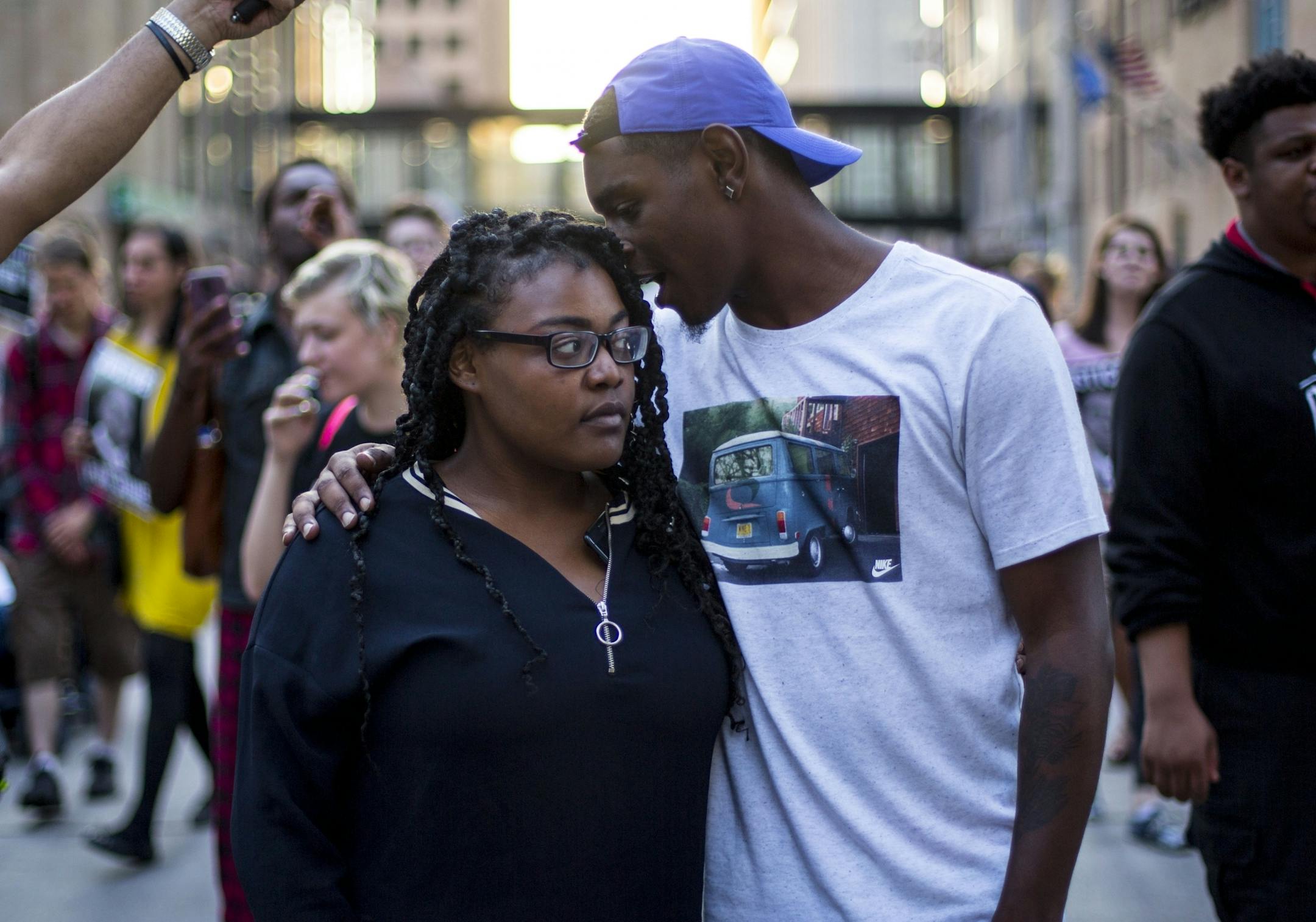 Sydne Brown listens as her family friend, Phinesse, talks to her about making history with the march.