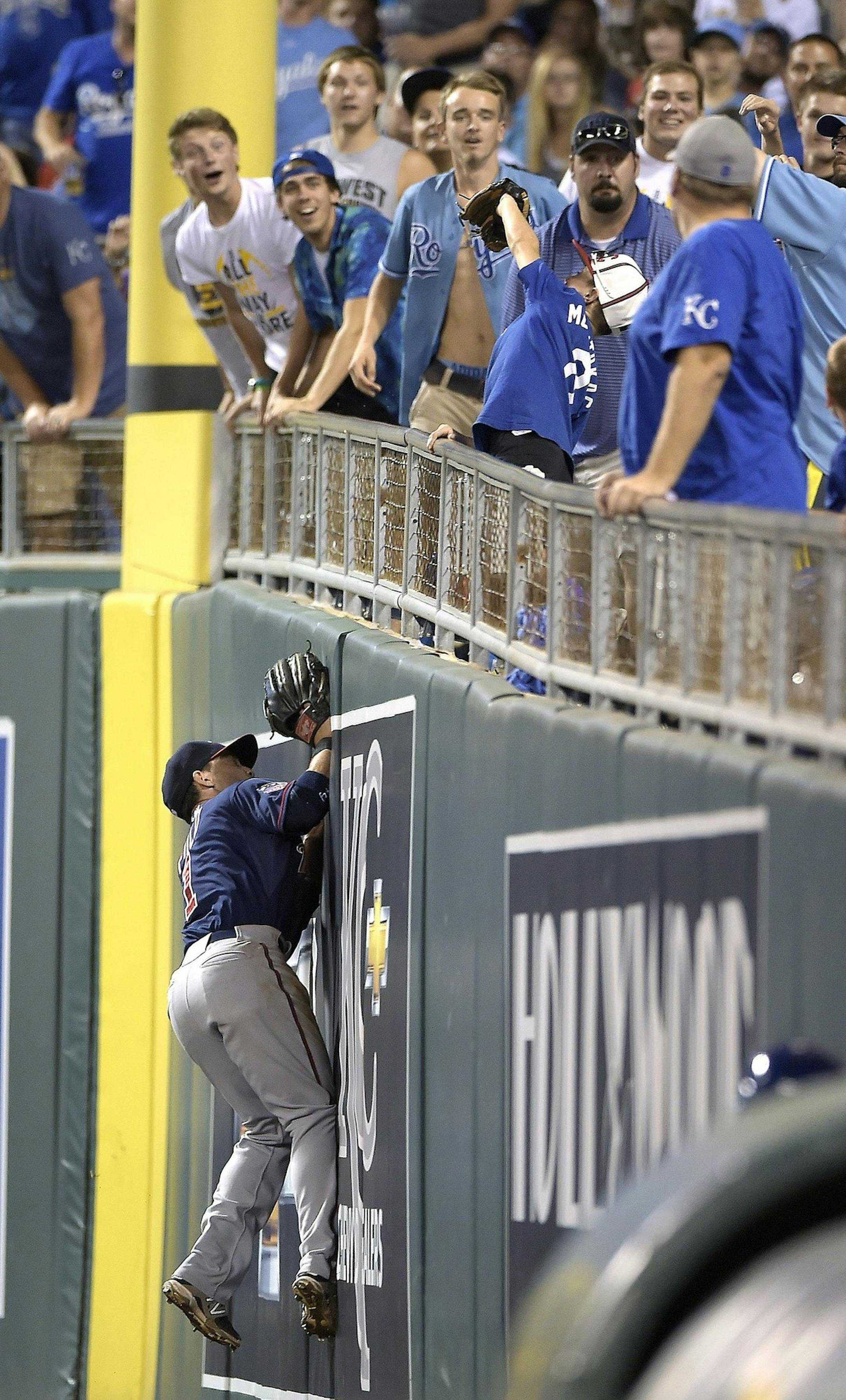 A young fan catches a foul ball over Minnesota Twins right fielder Sam Fuld against the Kansas City Royals in the eighth inning on Tuesday, July 29, 2014, at Kauffman Stadium in Kansas City, Mo. The Twins won, 2-1. (John Sleezer/Kansas City Star/MCT)