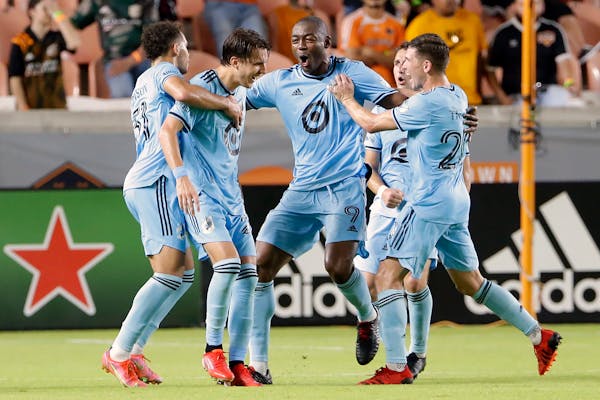 Fanendo Adi (middle) celebrated with his Loons teammates after a goal against Houston on Aug. 28.