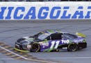 Denny Hamlin crosses the finish line as he wins the NASCAR Sprint Cup Series auto race at Chicagoland Speedway, Sunday, Sept. 20, 2015, in Joliet, Ill