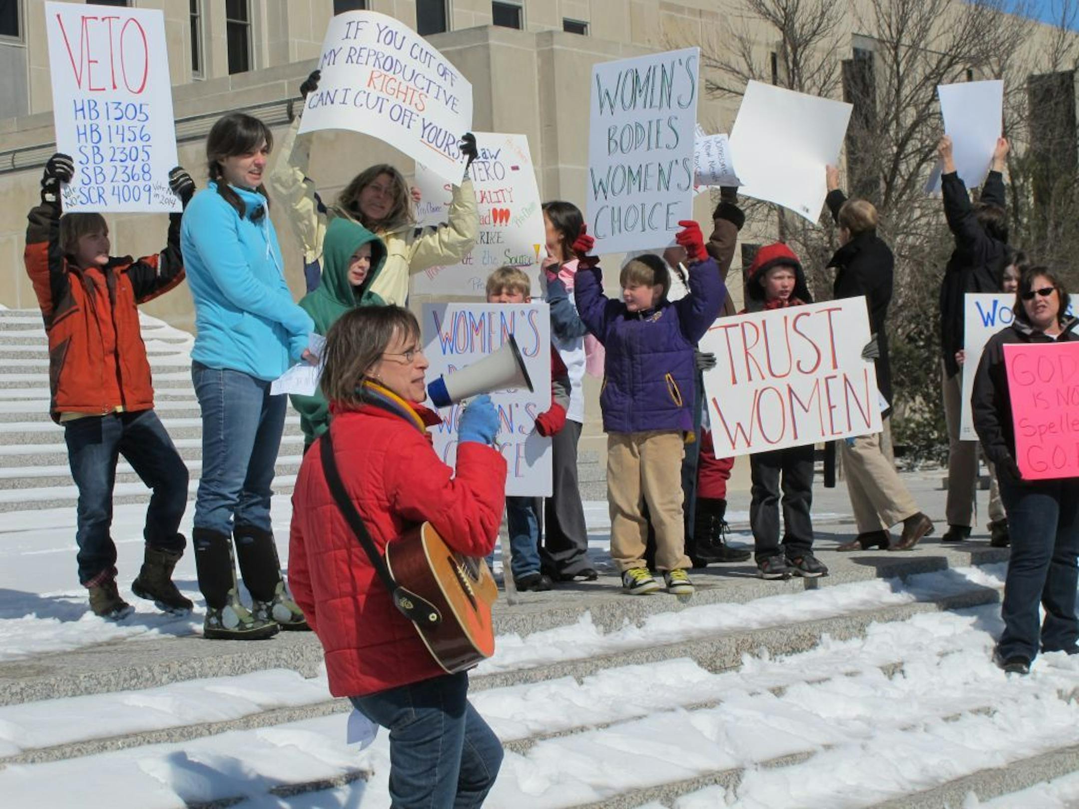 Kris Kitko leads chants of protest at an abortion-rights rally at the state Capitol in Bismarck, N.D., on Monday.