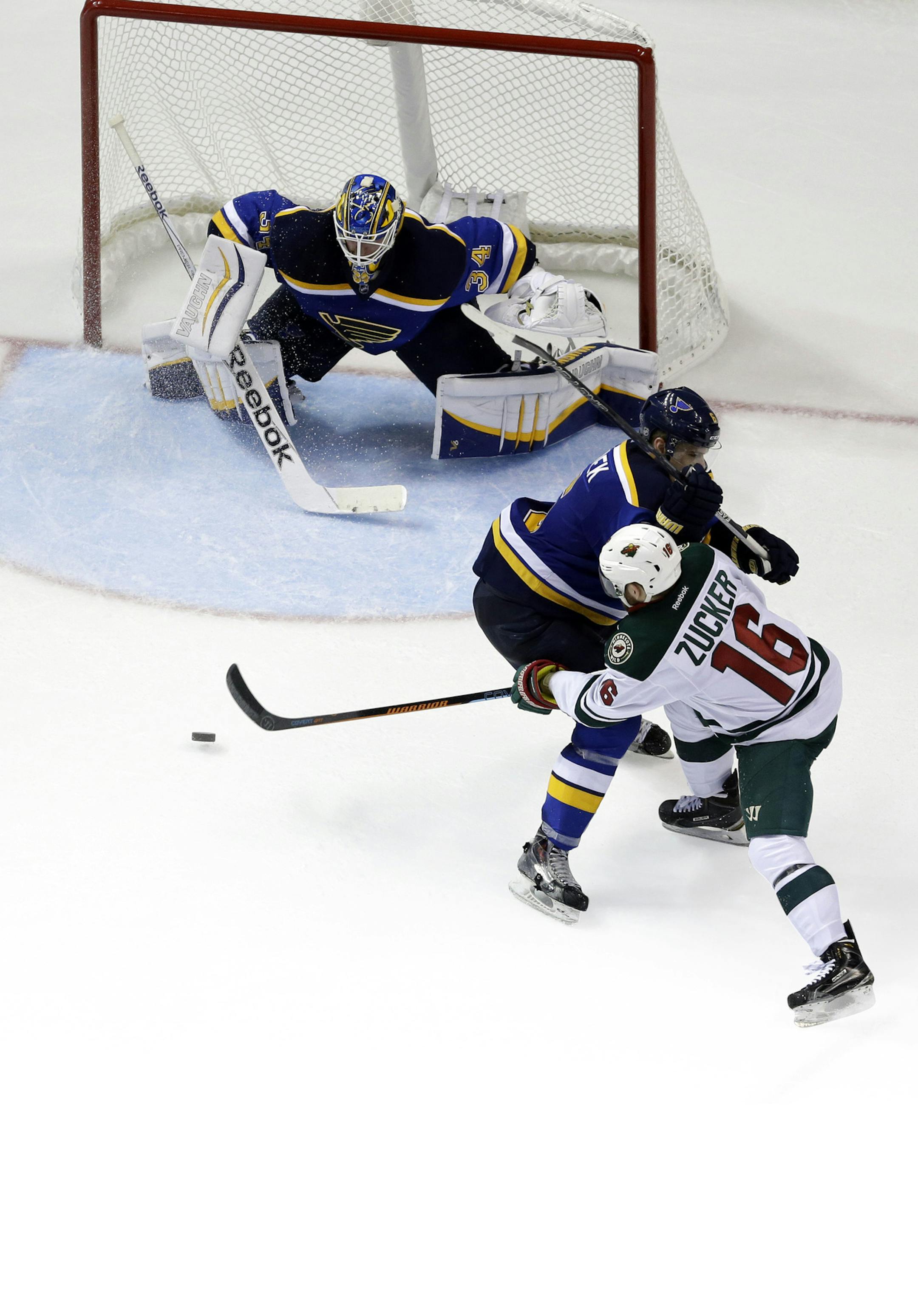Minnesota Wild's Jason Zucker (16) tries to get his stick on the puck as St. Louis Blues' Zbynek Michalek, of the Czech Republic, and goalie Jake Allen defend during the second period in Game 1 of an NHL hockey first-round playoff series, Thursday, April 16, 2015, in St. Louis. (AP Photo/Jeff Roberson) ORG XMIT: MIN2015041716363447