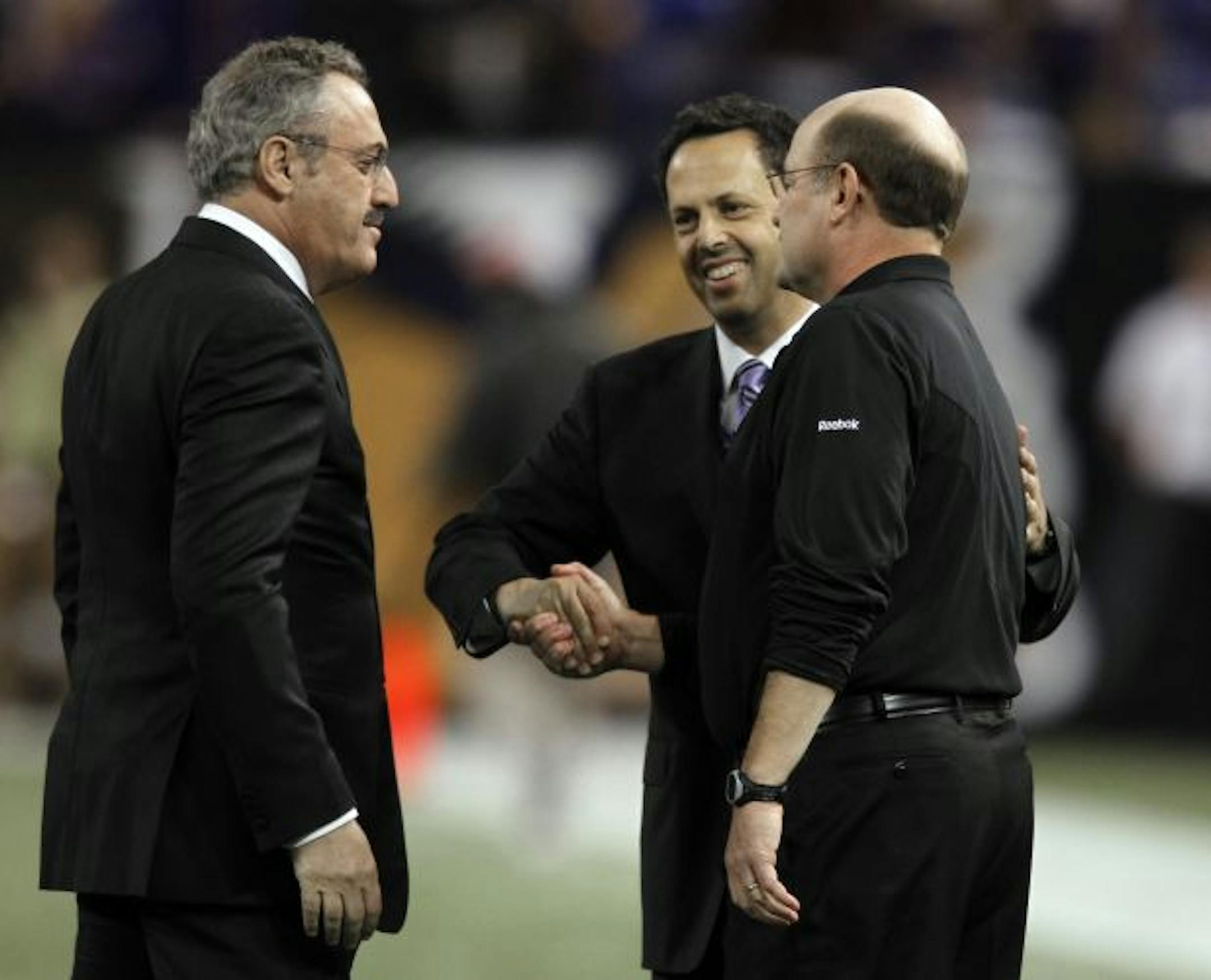 At the Metrodome in game between the Arizona Cardinals and the Minnesota Vikings,----Vikings owners Zygi left and Mark Wilf shook hands with Vikings troubled coach Brad Childress Sunday during pregame events.