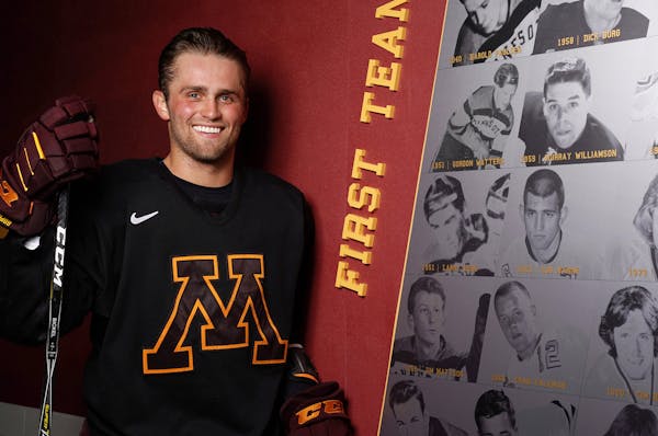 Gophers hockey senior captain Tyler Nanne stood for a portrait next to a first team board with a photograph of his grandfather, Lou Nanne, from 1963 n