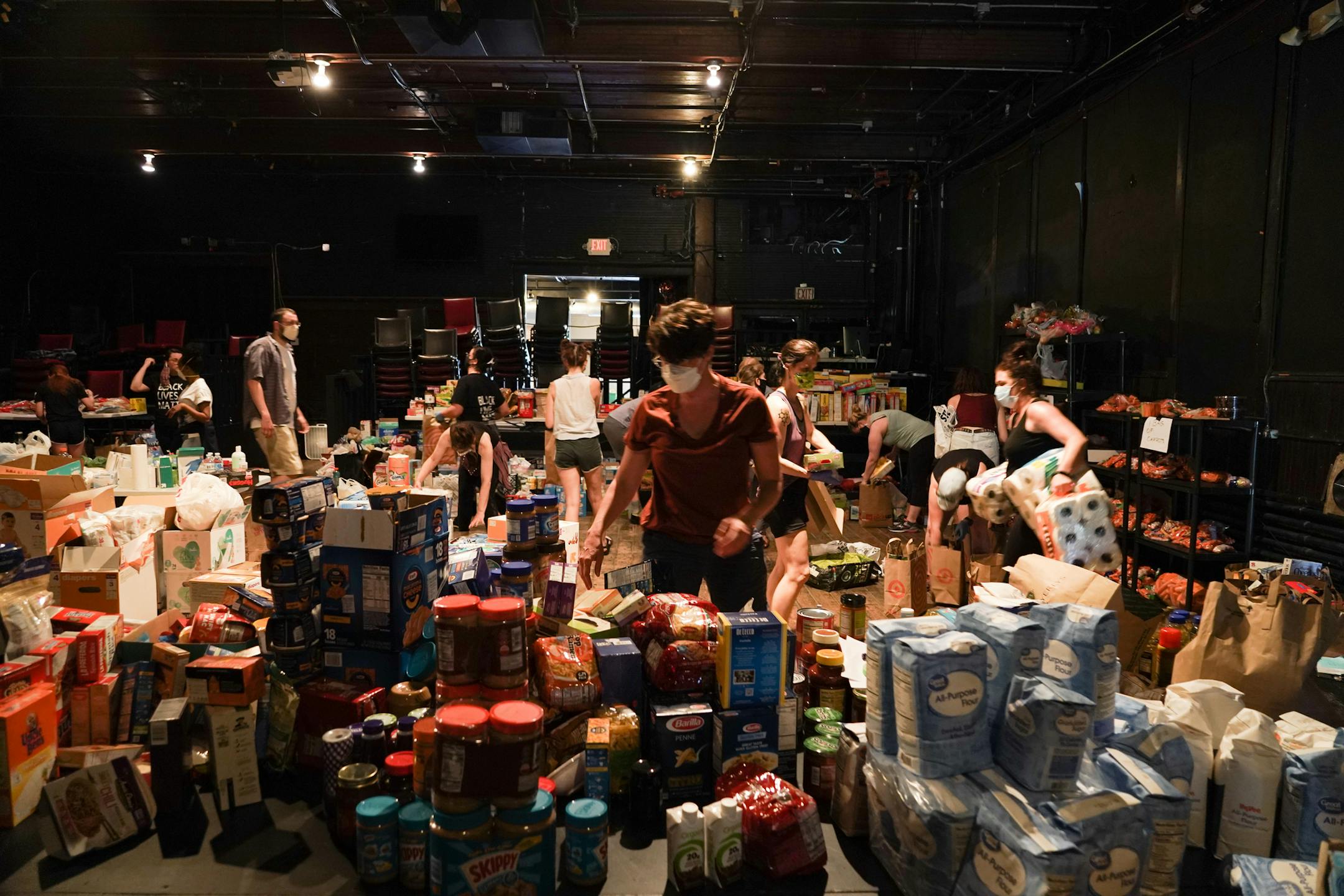 Volunteers organized donations at Mixed Blood Theatre in Minneapolis. The theater is operating as an emergency food shelter for its neighbors.
