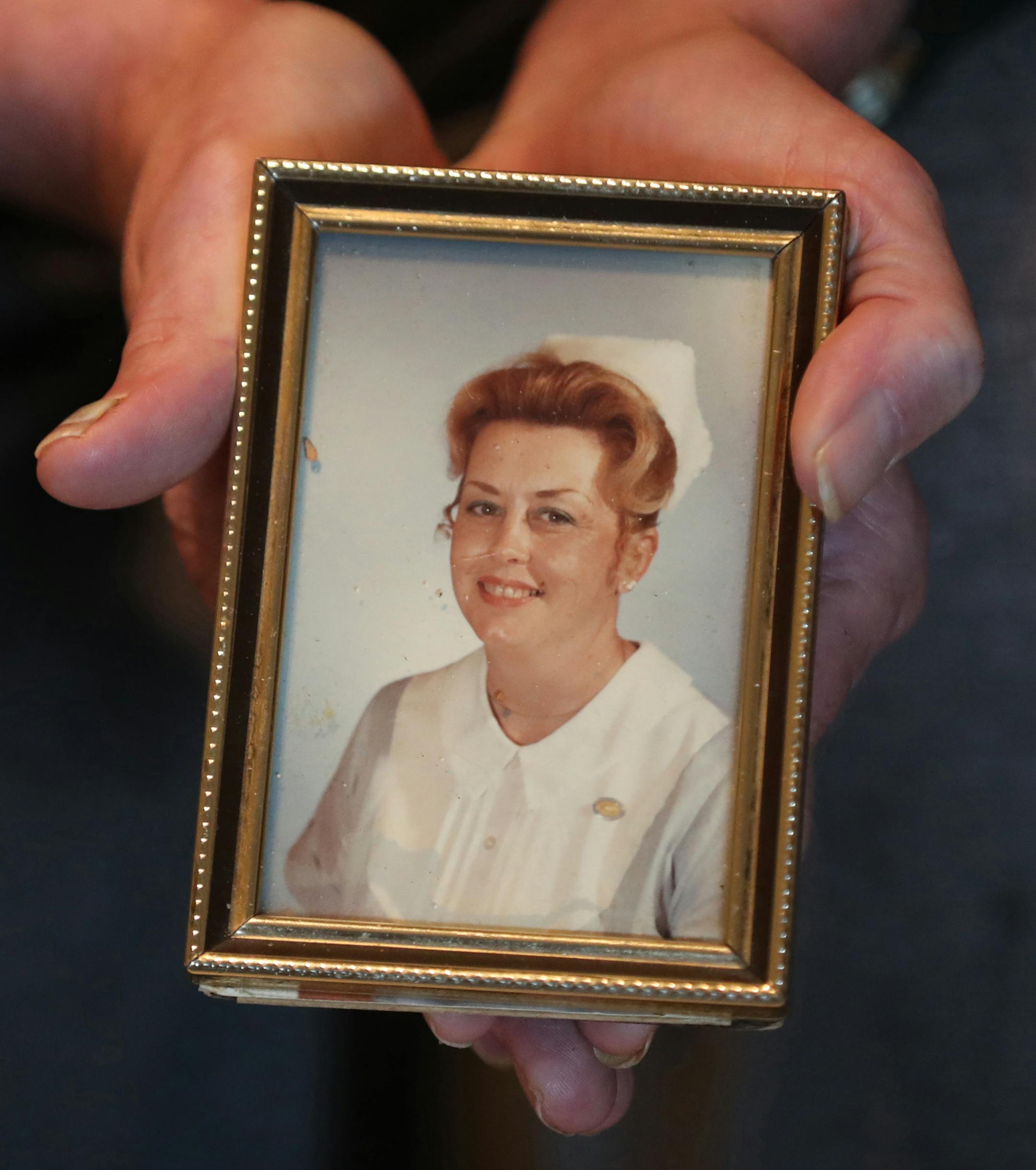 Robert Krause, 60, holds a photo of his mother Jean Krause, 78, once a registered nurse, who was sexually assaulted at "Heritage House," in Pequot Lakes by a nursing assistant there while in the late stages of Alzheimer's disease.