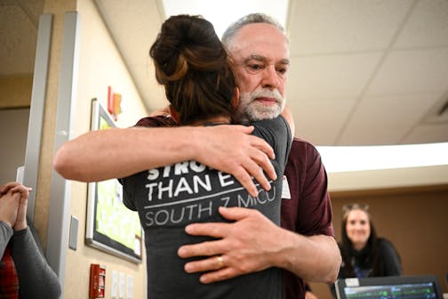 COVID survivor Rick Ulrich, of Norwood Young America, embraces critical care nurse Holly Vilione Thursday, May 11, 2023, at North Memorial Health Hospital's South Seven Intensive Care Unit in Robbinsdale, Minn. Ulrich returned to North Memorial with his wife Deb and two daughters to bring lunch and thank the healthcare workers he credits for saving his life during his nearly month-long stay in the ICU in late 2020.