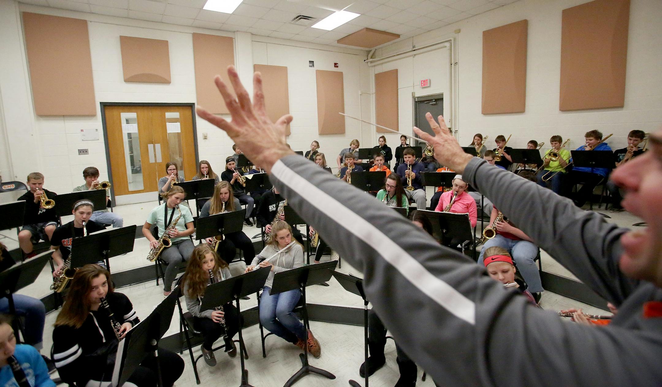 Erik Hermanson, band teacher and football coach at Cleveland Public School, where almost 90 percent of the school's students play in band, directs 7th and 8th grade band practice Tuesday, Feb. 21, 20117, in Cleveland, MN.