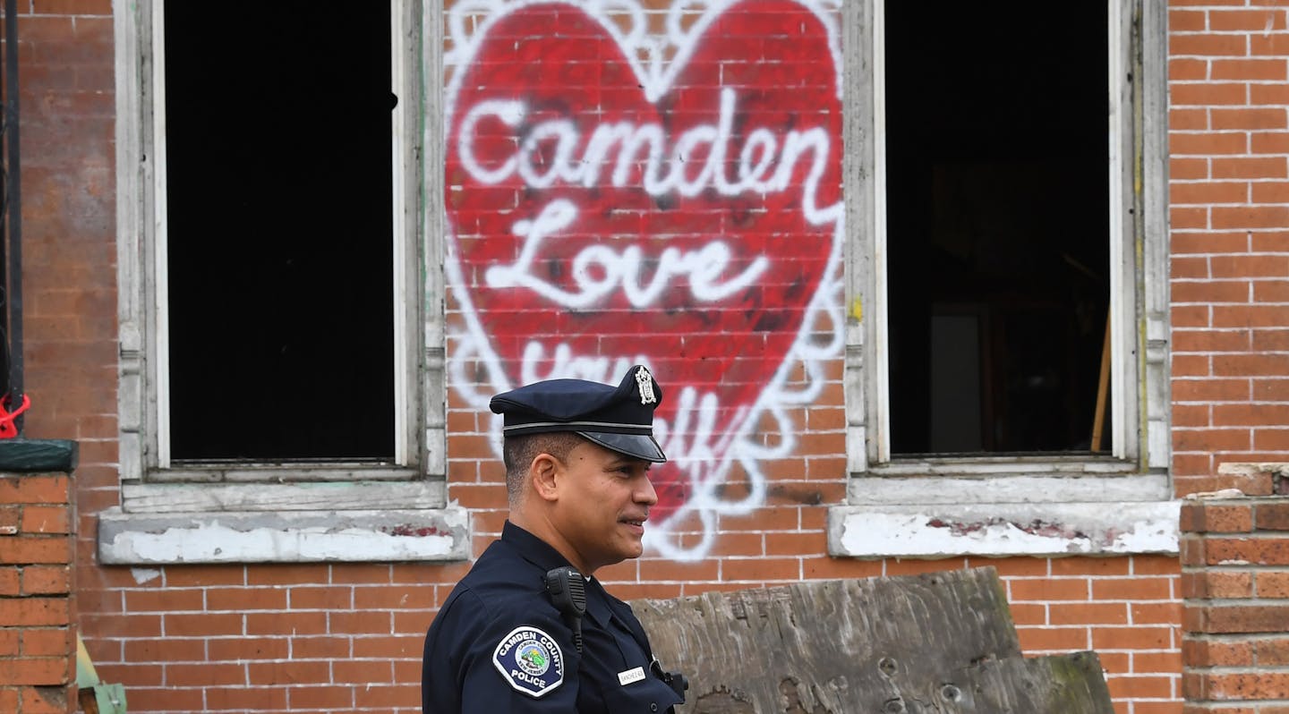 Camden County Police Department officer Louis Sanchez is seen on foot patrol in Camden, New Jersey, on May 24, 2017. In 2013 the city of Camden, New Jersey, dissolved its police force, replacing it with a new county-run department where they are turning around a city that had one of the highest crime rates in the country. Police reform and falling crime statistics turned Camden into a poster child for better policing. (Timothy A. Clary/AFP/Getty Images/TNS) ORG XMIT: 1686357