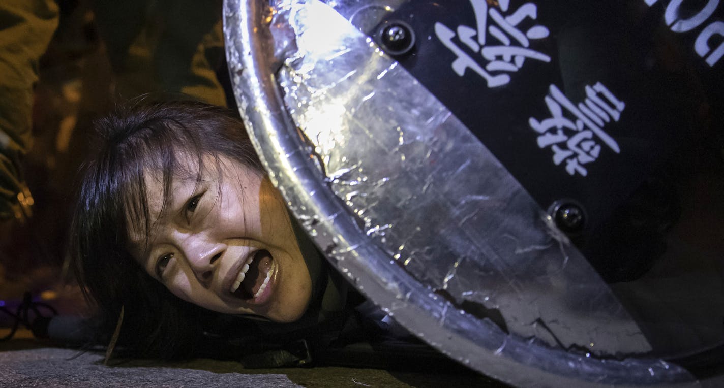 This Sept. 2, 2019 photo by Reuters photographer Tyrone Siu, provided by Columbia University, shows an anti-extradition bill protester detained by riot police during skirmishes between the police and protesters outside Mong Kok police station, in Hong Kong, China. The photography staff of Reuters was awarded the 2020 Pulitzer Prize for Breaking News Photography, in New York, Monday May 4, 2020, for wide-ranging and illuminating photographs of Hong Kong as citizens protested infringement of their