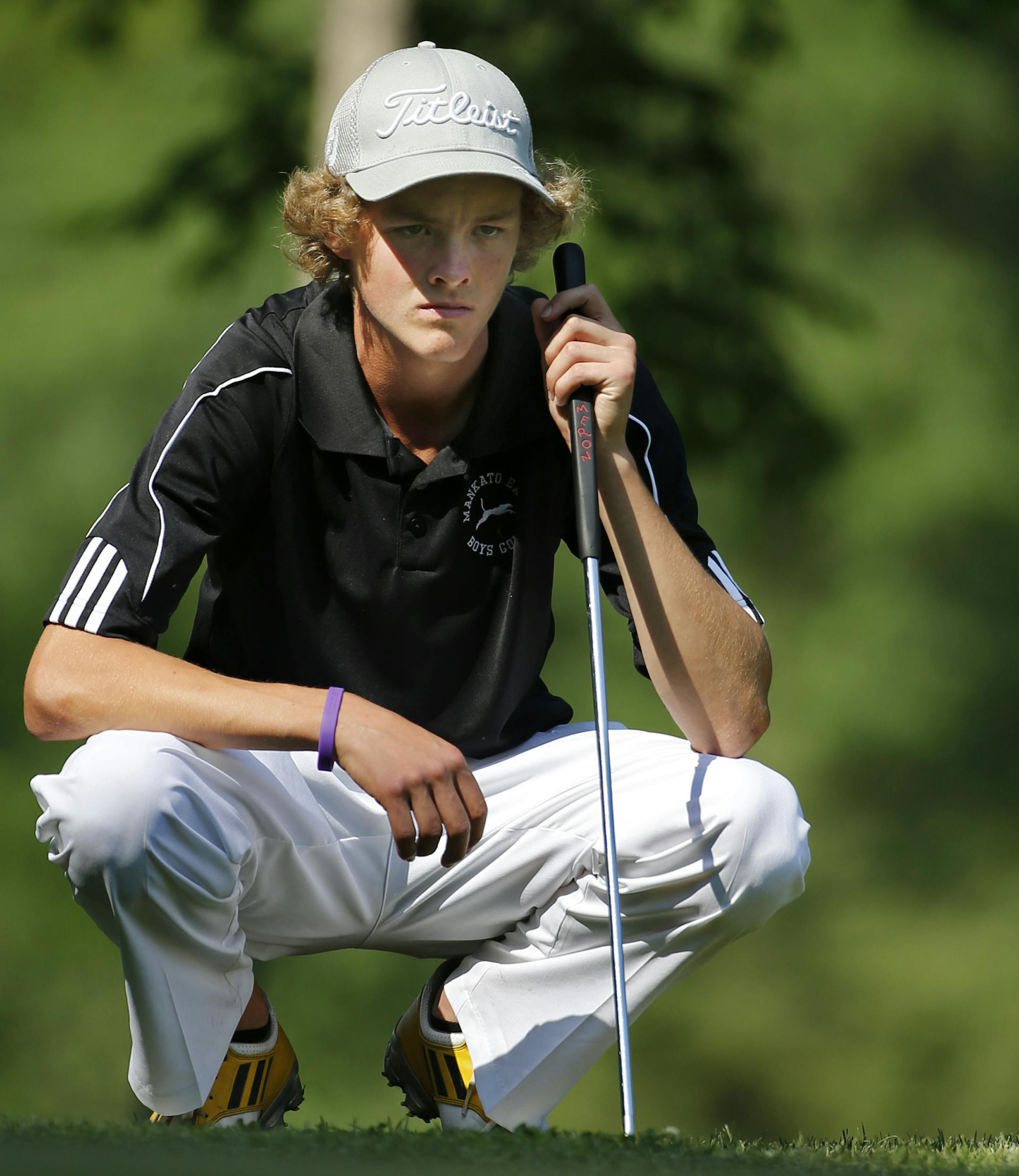 At the 2A golf tournament at Ridgesat Sand Creek in Jordan on June 11, 2014, Carter Haley of Mankato East sized up a putt .]richard.tsong-taatarii/rtsong-taatarii@startribune.com