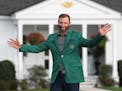 Dustin Johnson celebrated winning his first green jacket in front of the Eisenhower Cabin after winning the Masters on Sunday.