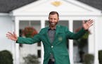 Dustin Johnson celebrated winning his first green jacket in front of the Eisenhower Cabin after winning the Masters on Sunday.
