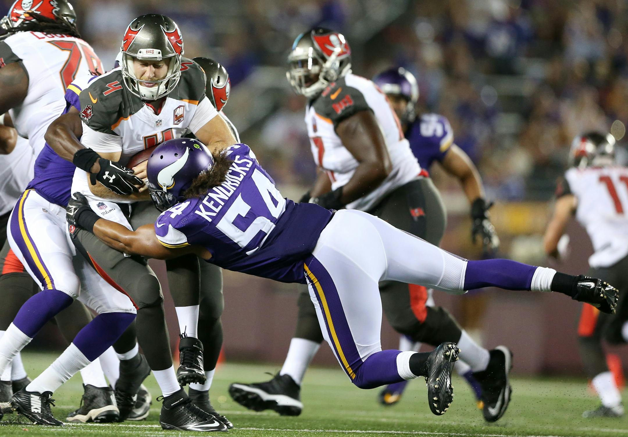 Vikings inside linebacker Eric Kendricks (54) sacked Buccaneers quarterback Seth Lobato in the fourth quarter during a preseason game.