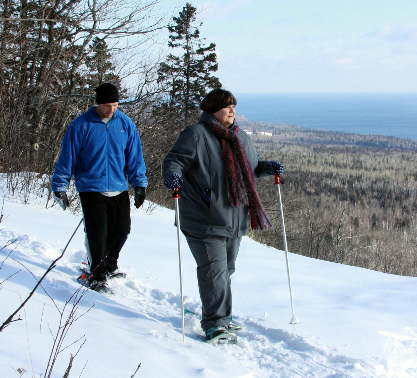 photo by Beth Probst snowshoe3 - Lori Schaefer and Fitness progran director Leif Anderson hike along Oberg Mountain overlooking Lake Superior.