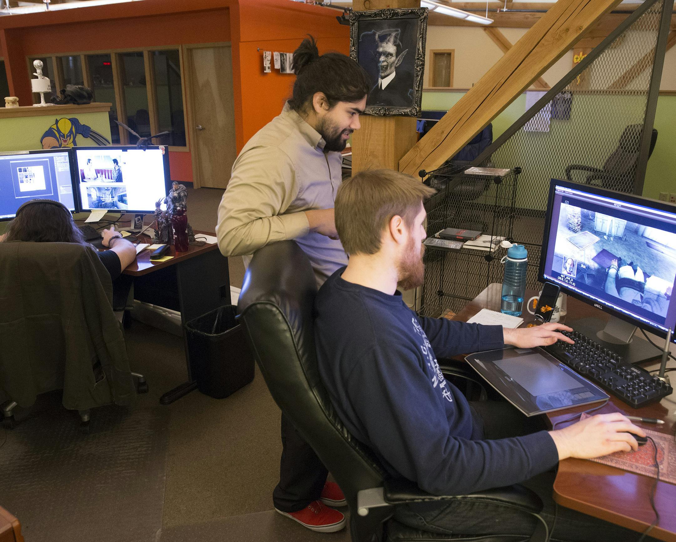 Production artist Grabiel Ruiz speaks with environment artist Nick Myrold, right, on December 3, 2014 at Human Head Studios in Madison, Wis. (Mark Hoffman/Milwaukee Journal Sentinel/TNS) ORG XMIT: 1161489