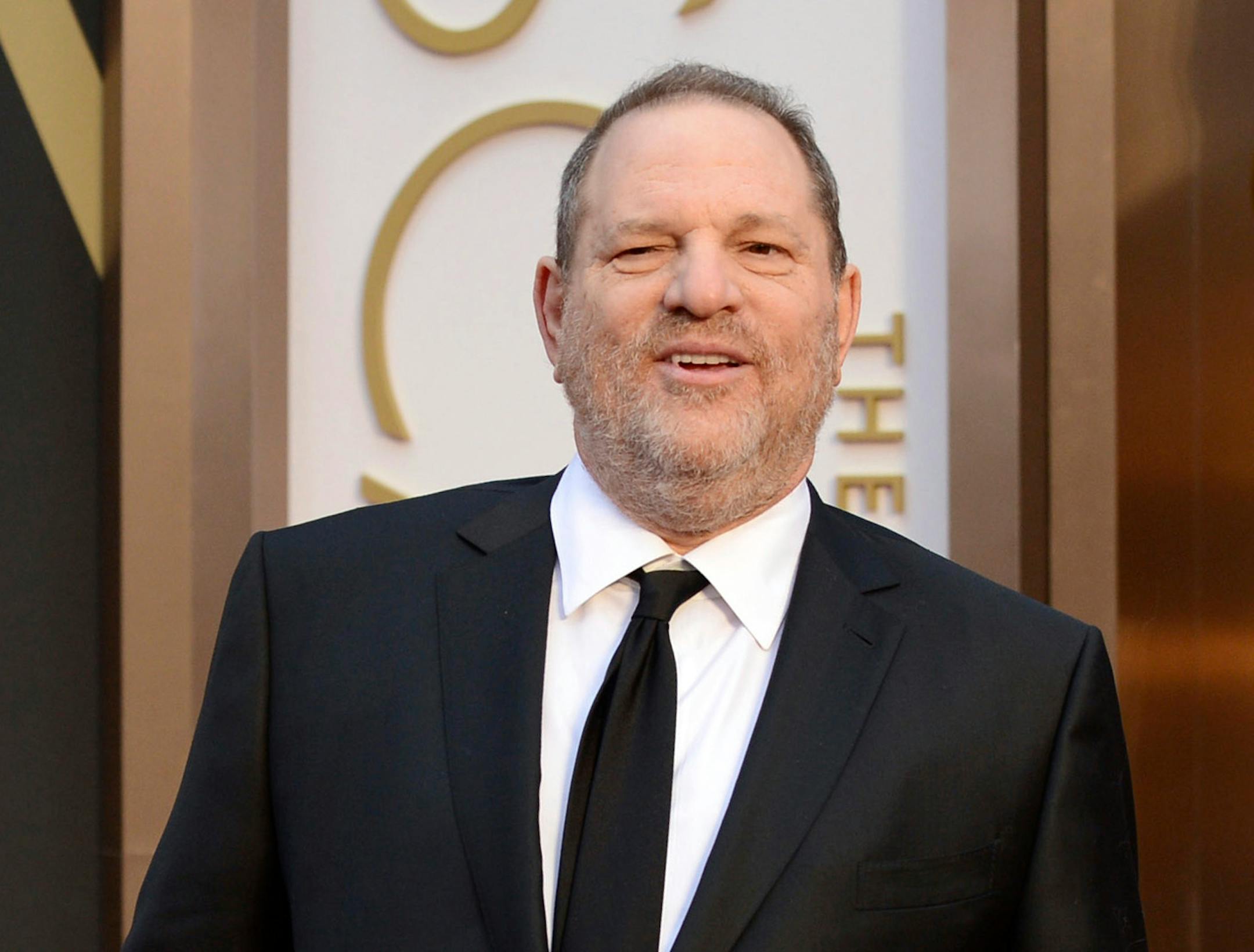 FILE - In this March 2, 2014 file photo, Harvey Weinstein arrives at the Oscars in Los Angeles. Day by day, the accusations pile up, as scores of women come forward to say they were victims of Weinstein. But others with stories to tell have not. For some of these women who've chosen not to go public, the fear of being associated forever with the sordid scandal _ and the effects on their careers, and their lives _ might be too great. Or they may still be struggling with the lingering effects of t