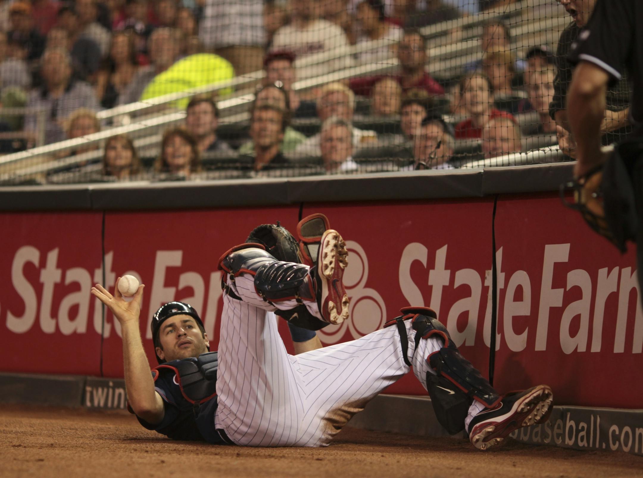 Seattle ace Felix Hernandez shut out the Minnesota Twins as the Mariners edged the Twins 1-0 Monday night, August 27, 2012, at Target Field in Minneapolis, Minn. Twins catcher Joe Mauer showed home plate umpire Paul Nauert that he had caught a foul pop by Seattle's Trayvon Robinson in the eighth innnig. Mauer became the Twins all-time leader in games caught with his 832 career game at the position Monday night, surpassing Earl Battey.