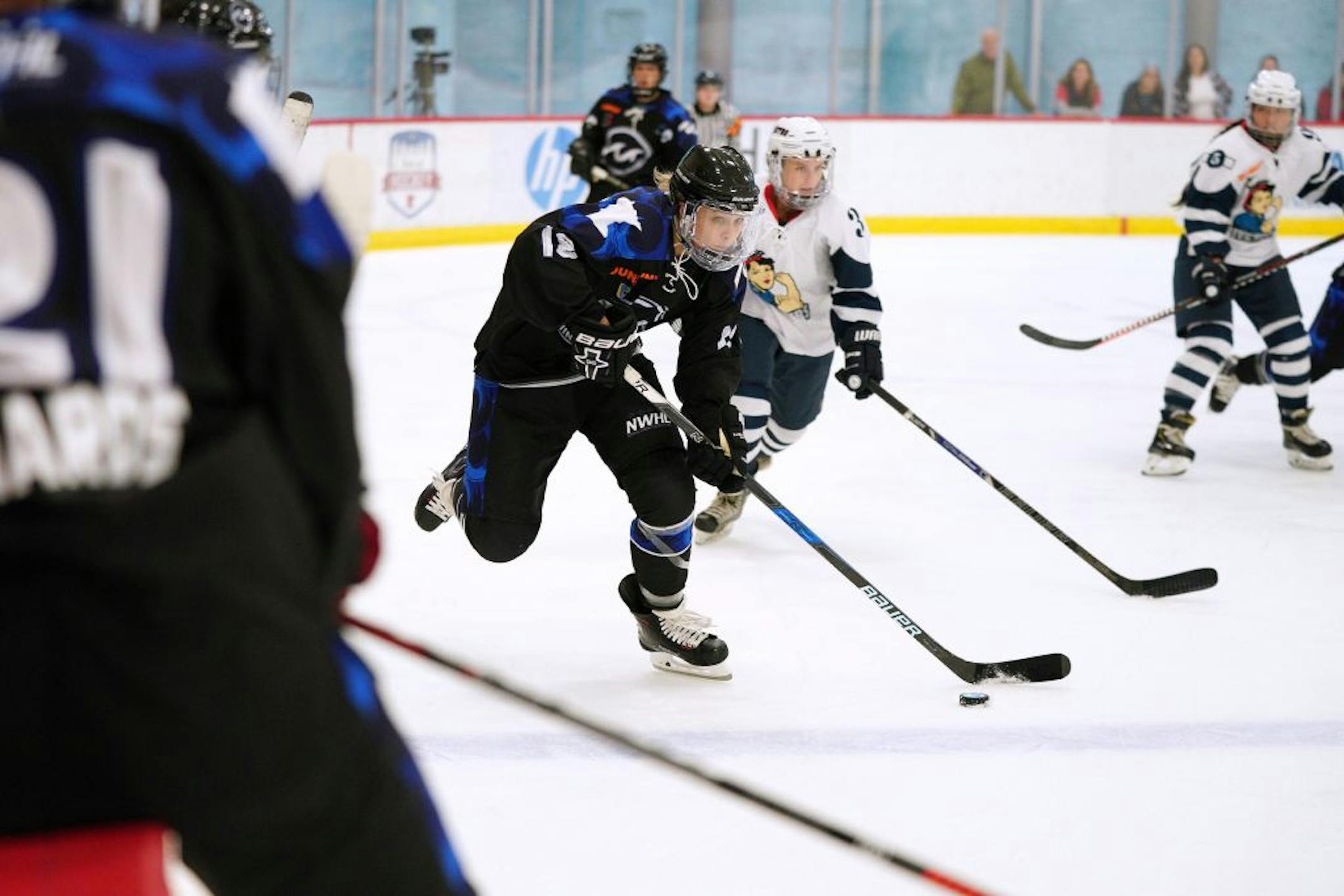 Whitecaps forward Stephanie Anderson (18) took the puck down the ice during Saturday's game.