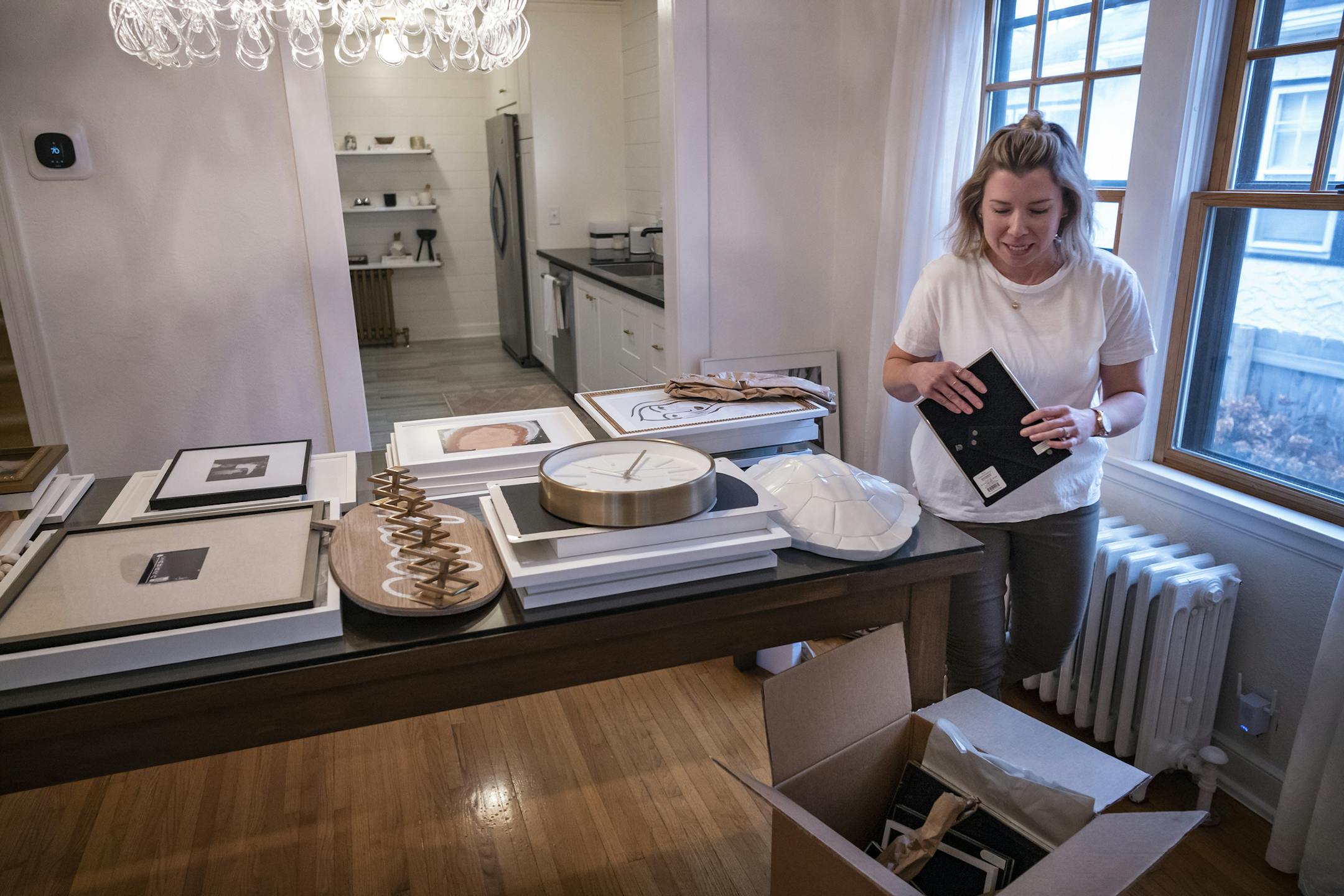 Brooke Bundy, an interior designer is packing for their move to Dallas, Texas where her husband has been transferred. They listed their house for $399,900. Within a day they had multiple offers. Sales closes next week. ] RICHARD TSONG-TAATARII ¥ richard.tsong-taatarii@startribune.com