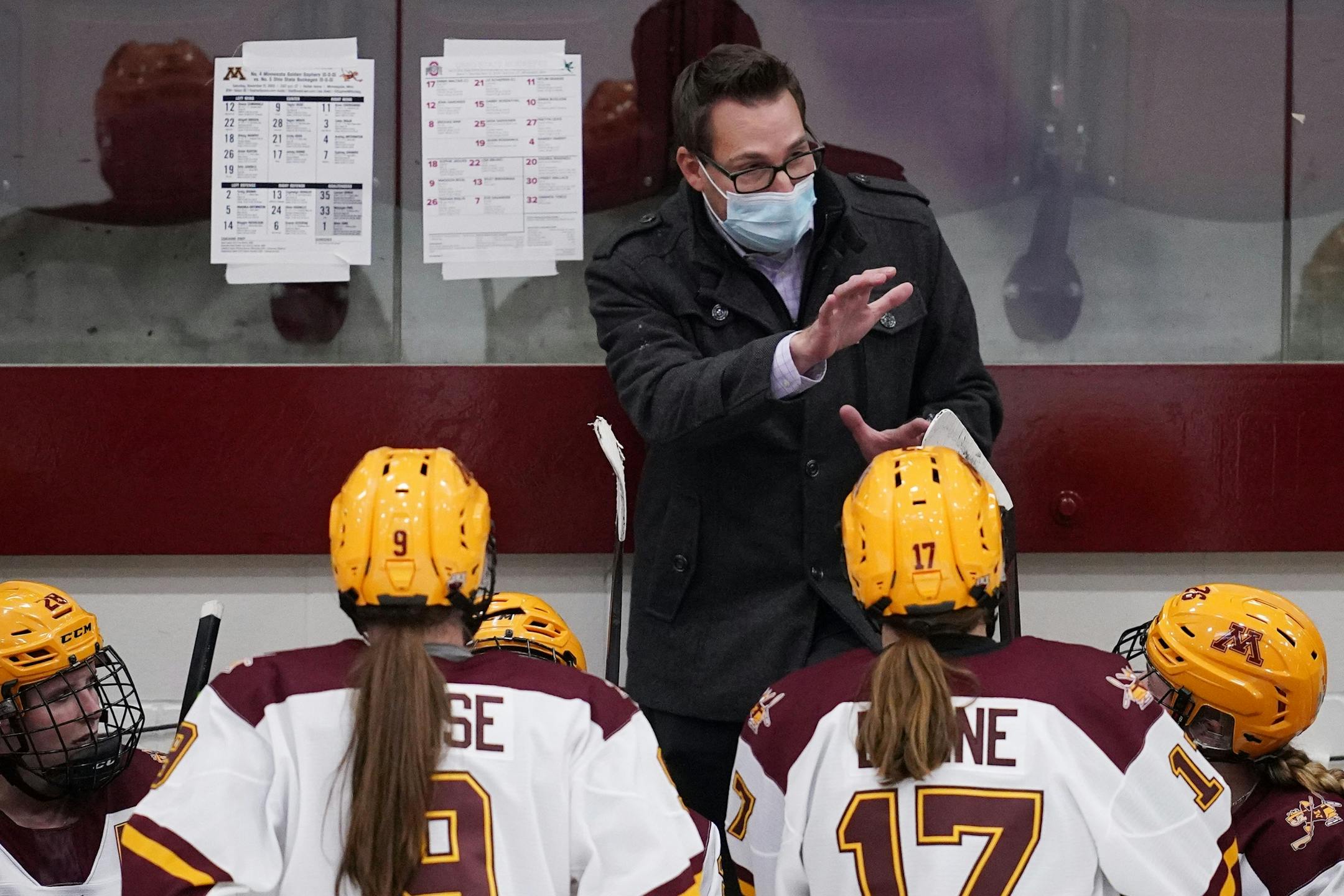 Minnesota head coach Brad Frost talked with his players during a timeout in the third period.