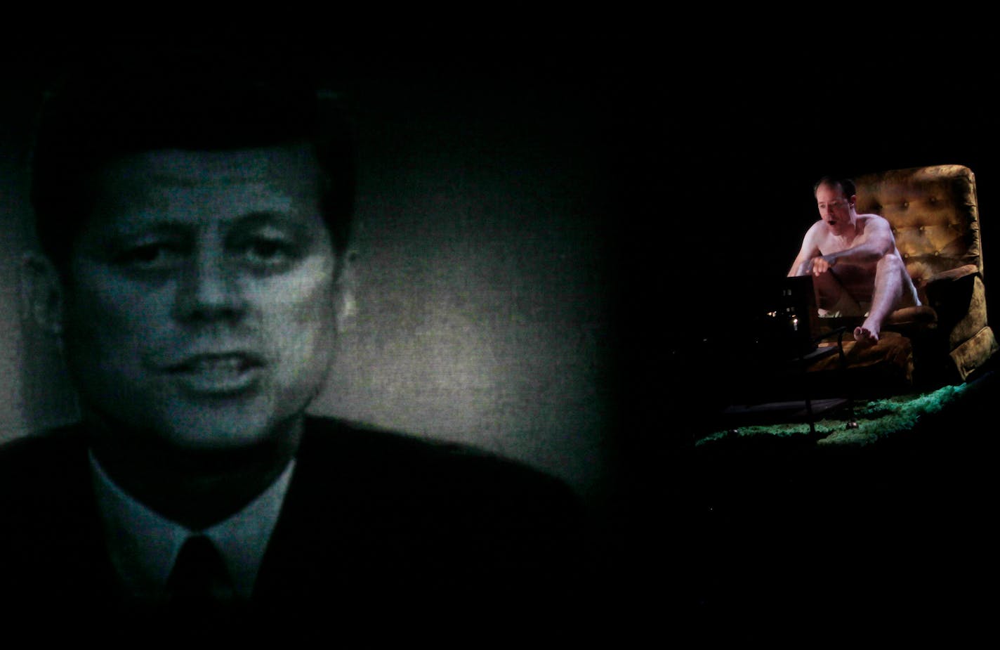 The play heats up during the second half, set during the 1960s. Above, Michael Milligan as Lee Harvey Oswald watches President John F. Kennedy speak on civil rights in 1963.