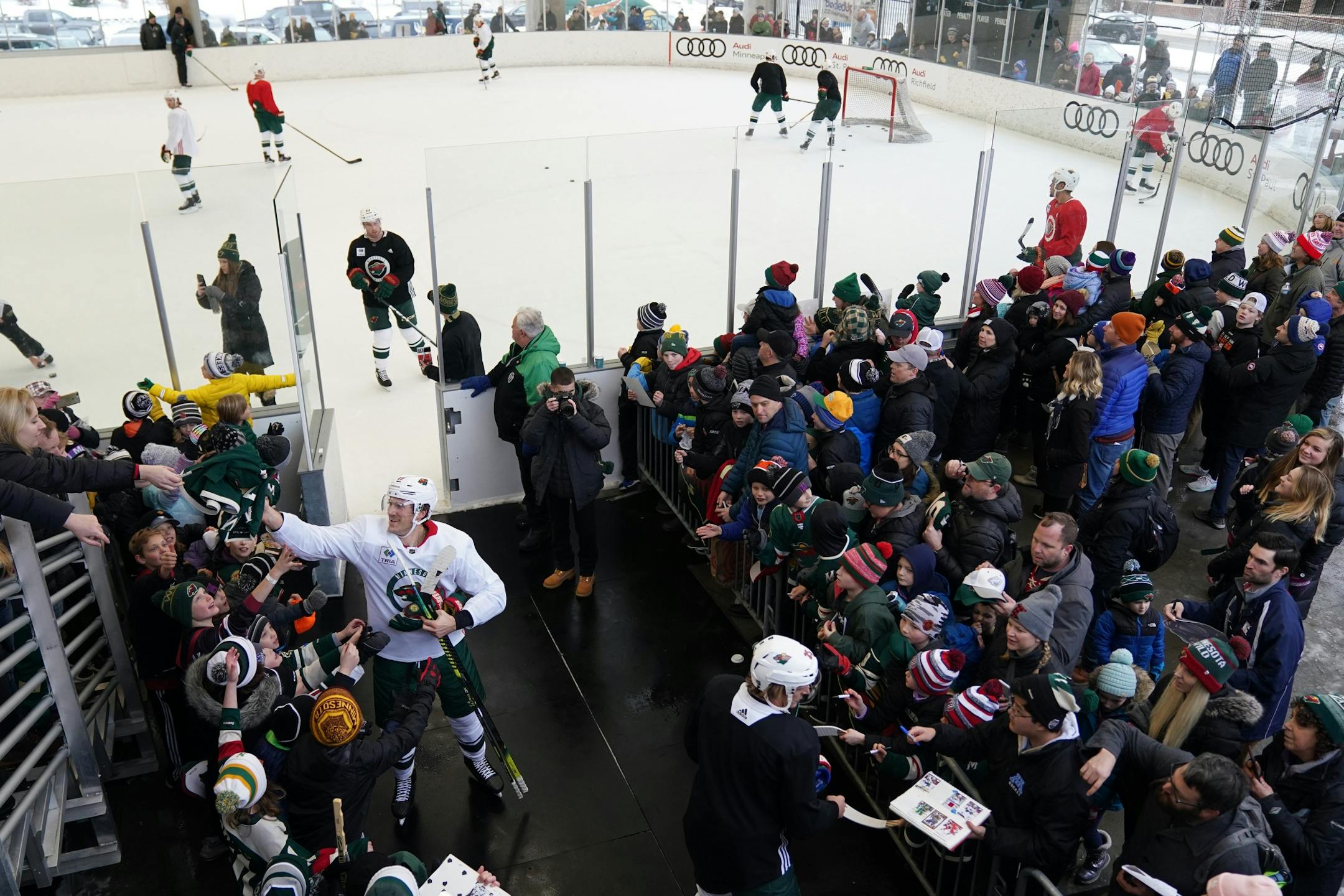 Minnesota Wild left wing Marcus Foligno (17) and defenseman Jonas Brodin (25) signed autographs following the Wild's outdoor practice Thursday.