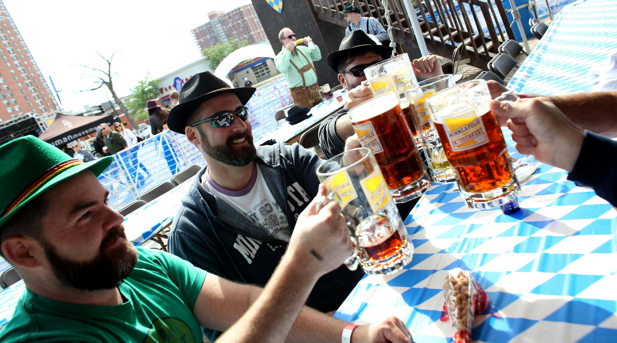 Mark Godwin, Ryan Whisenant and their friends toast each other  in the VIP tent.    ] (KYNDELL HARKNESS/STAR TRIBUNE) kyndell.harkness@startribune.com  Octoberfest in Minneapolis  Min., Saturday, September 13,  2014.