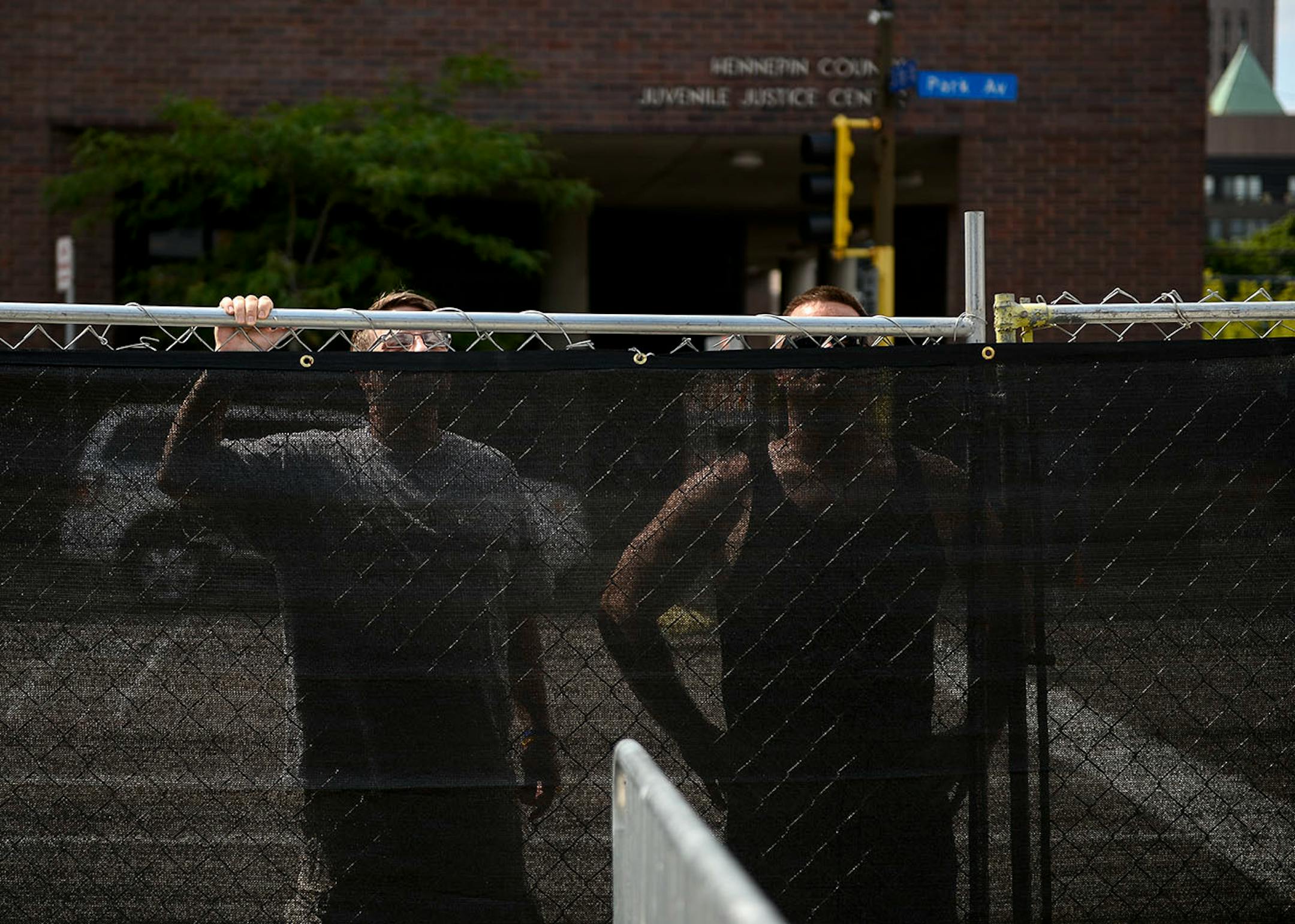 Two men, who did not want to be identified, vied for a better view of X Fest happenings from beyond a barrier blocking the Commons from public view.