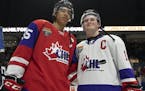 FILE - In this Jan. 16, 2020, file photo, Team Red center Quinton Byfield (55) and Team White left winger Alexis Lafreniere (11) pose for photos follo