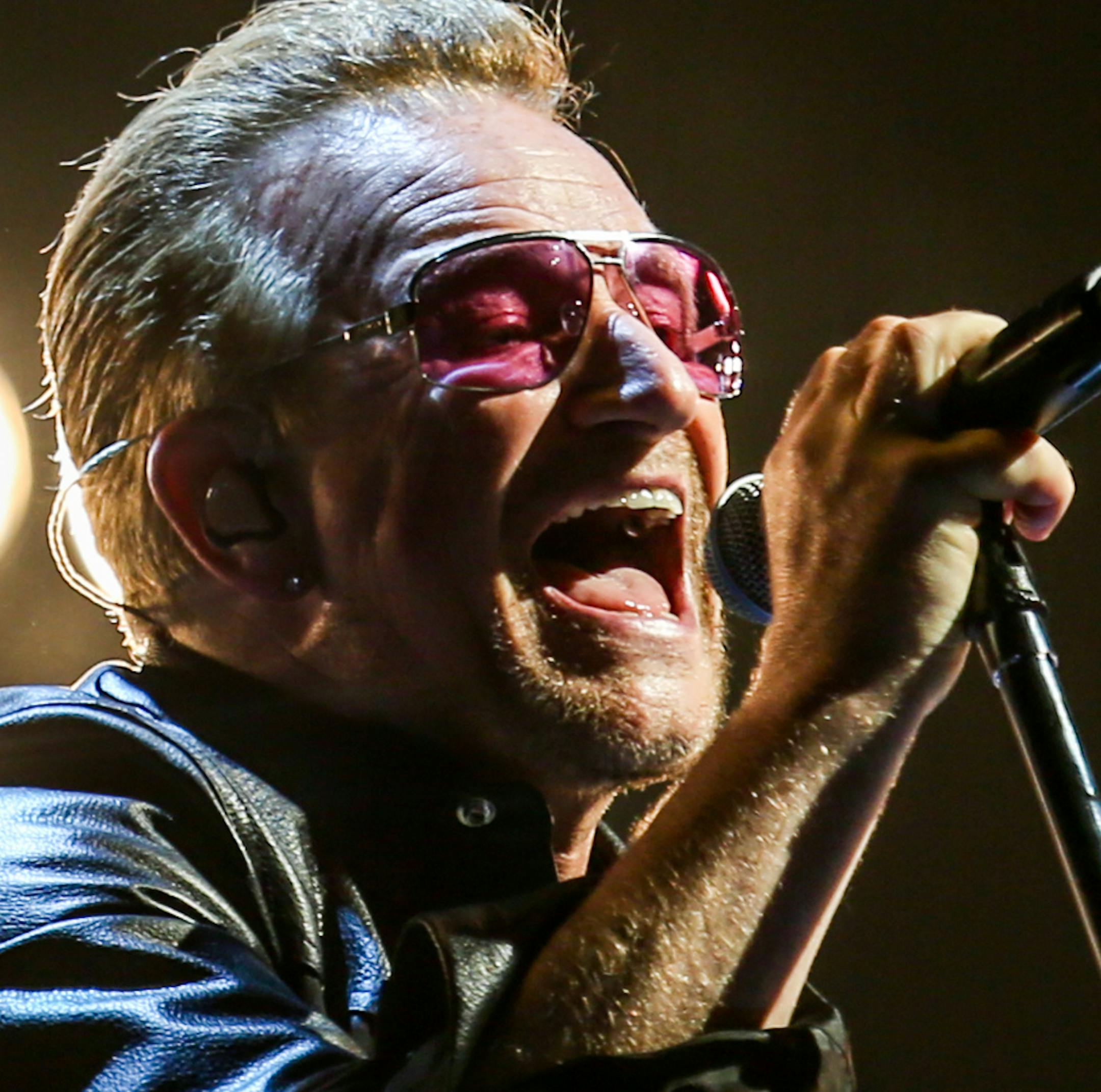 FILE - In this May 26, 2015 file photo, Bono of U2 performs at the Innocence + Experience Tour at The Forum in Inglewood, Calif. Bono, who has had problems with his own eyesight, is partnering with a company to provide better eye care to the underprivileged. Bono was diagnosed with glaucoma two decades ago and while he says his eyesight is now ok. But in a statement, Thursday, July 23, he said "tens of millions of people around the world with sight problems donít have access to glasses, or
