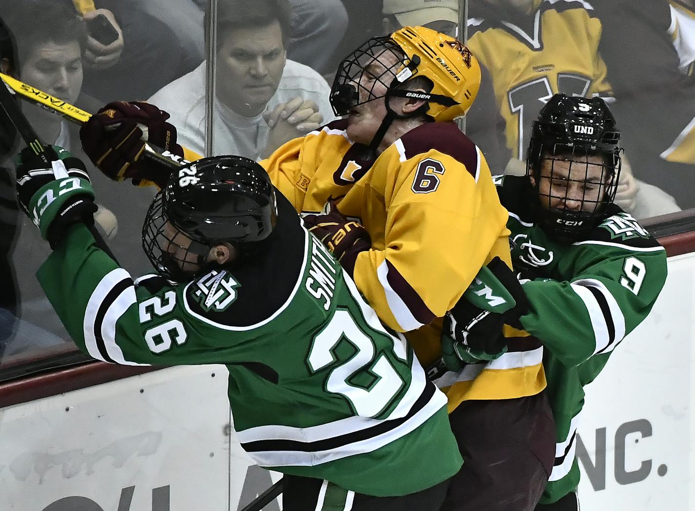 Minnesota Golden Gophers right defender Ryan Collins (6) took a hard check from North Dakota Fighting Hawks forward Cole Smith (26) and defenseman Dixon Bowen (9) in the first period Saturday. ] (AARON LAVINSKY/STAR TRIBUNE) aaron.lavinsky@startribune.com The University of Minnesota Golden Gophers men's hockey team played the University of North Dakota Fighting Hawks on Saturday, Nov. 5, 2016 at Mariucci Arena in Minneapolis, Minn.