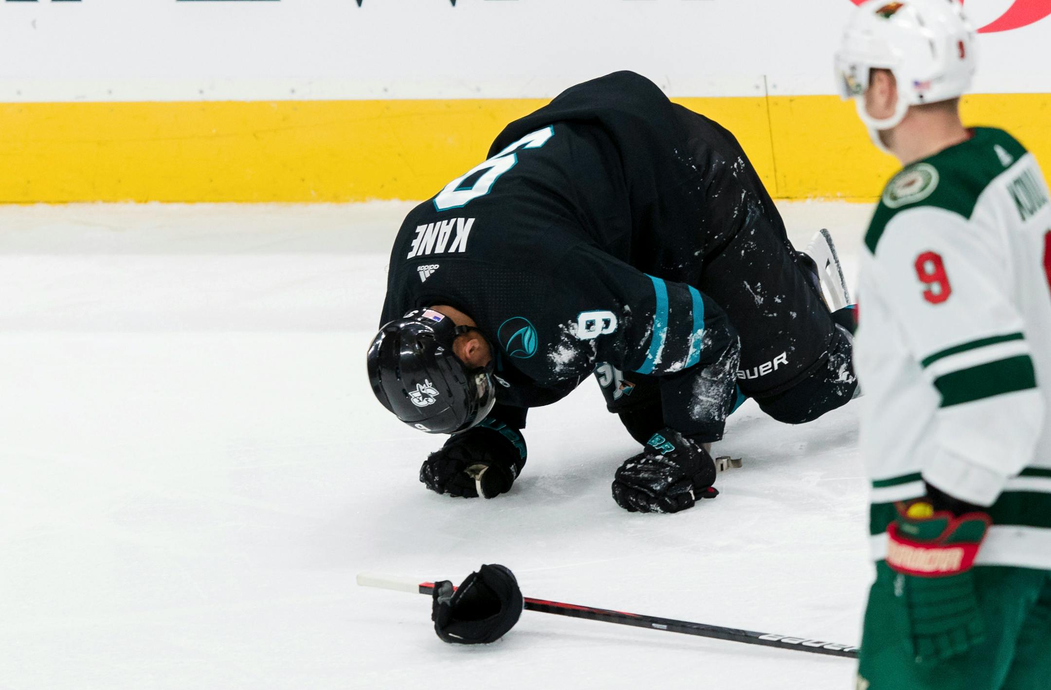 San Jose Sharks' Evander Kane falls to the ice after being injured in a collision with a Minnesota Wild player during the third period of an NHL hockey game, Thursday, Nov. 7, 2019, in San Jose, Calif. The Sharks won 6-5. (AP Photo/John Hefti)